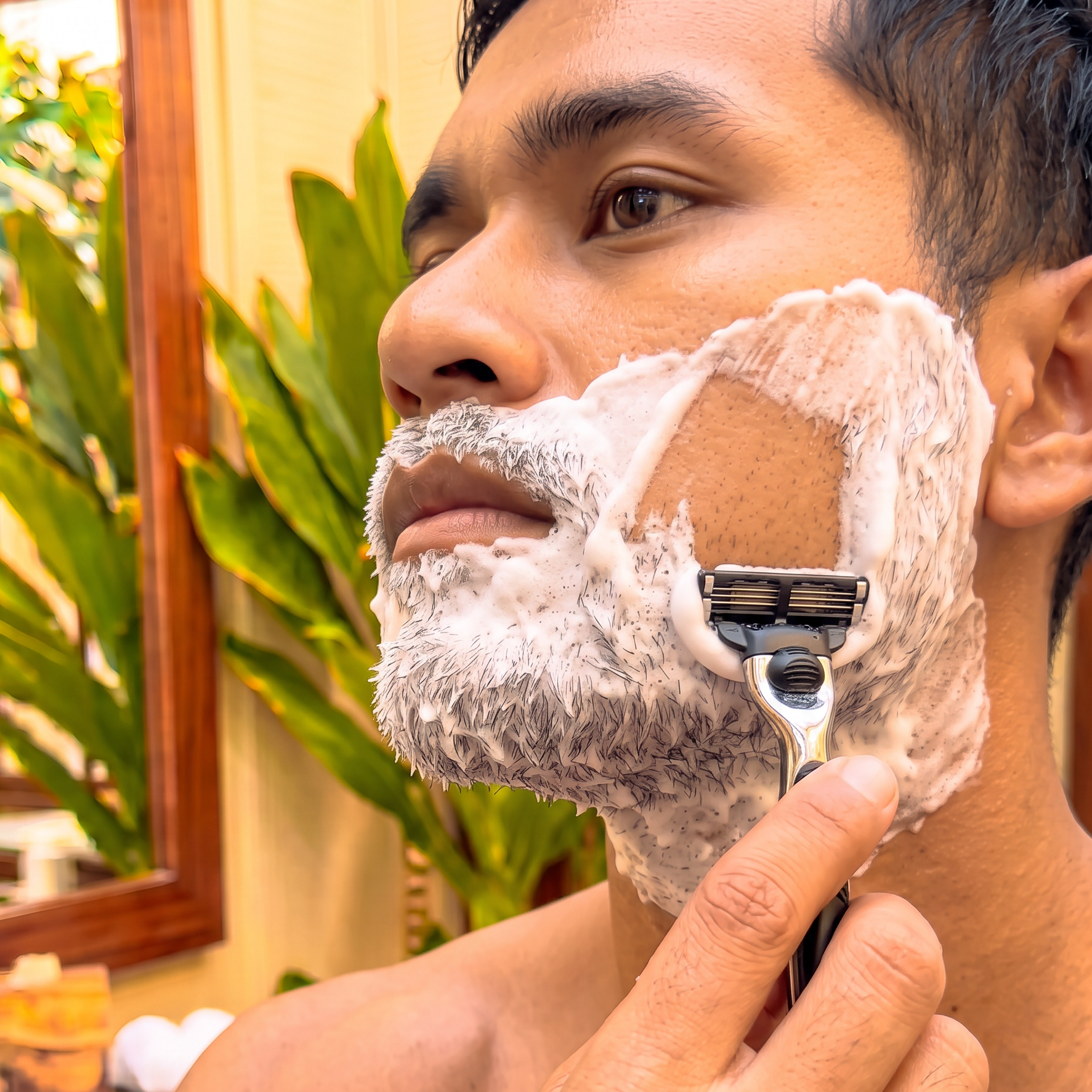 male model shaving his beard and facial hair with a razor after using The Centering Shave Ritual artisan soap puck by Kekoa Creative. (Copy) (Copy)