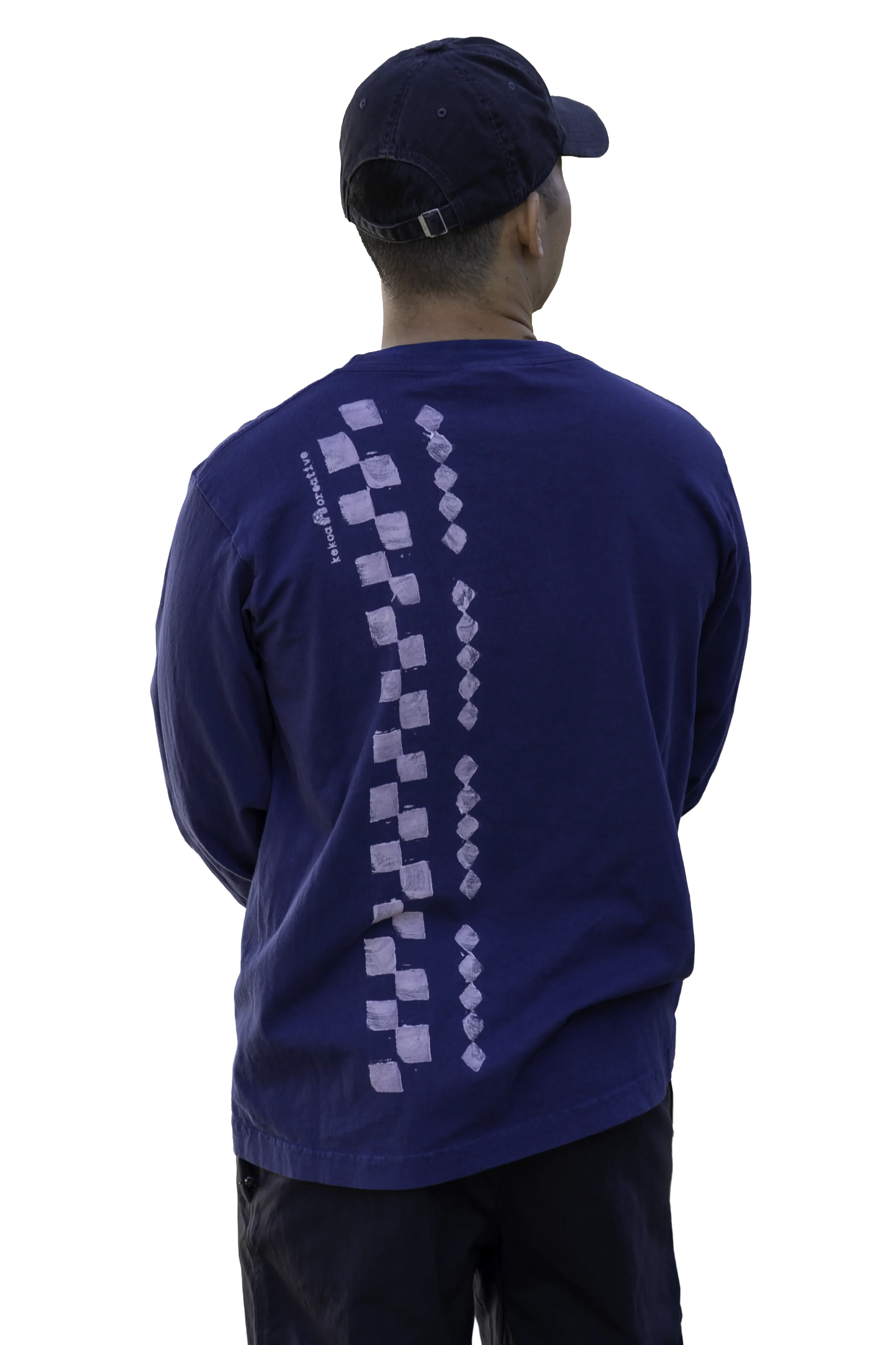 Back view of Dark Navy Kōnane long sleeve trash tee featuring vertical lālani column discharge print with zero hand feel.