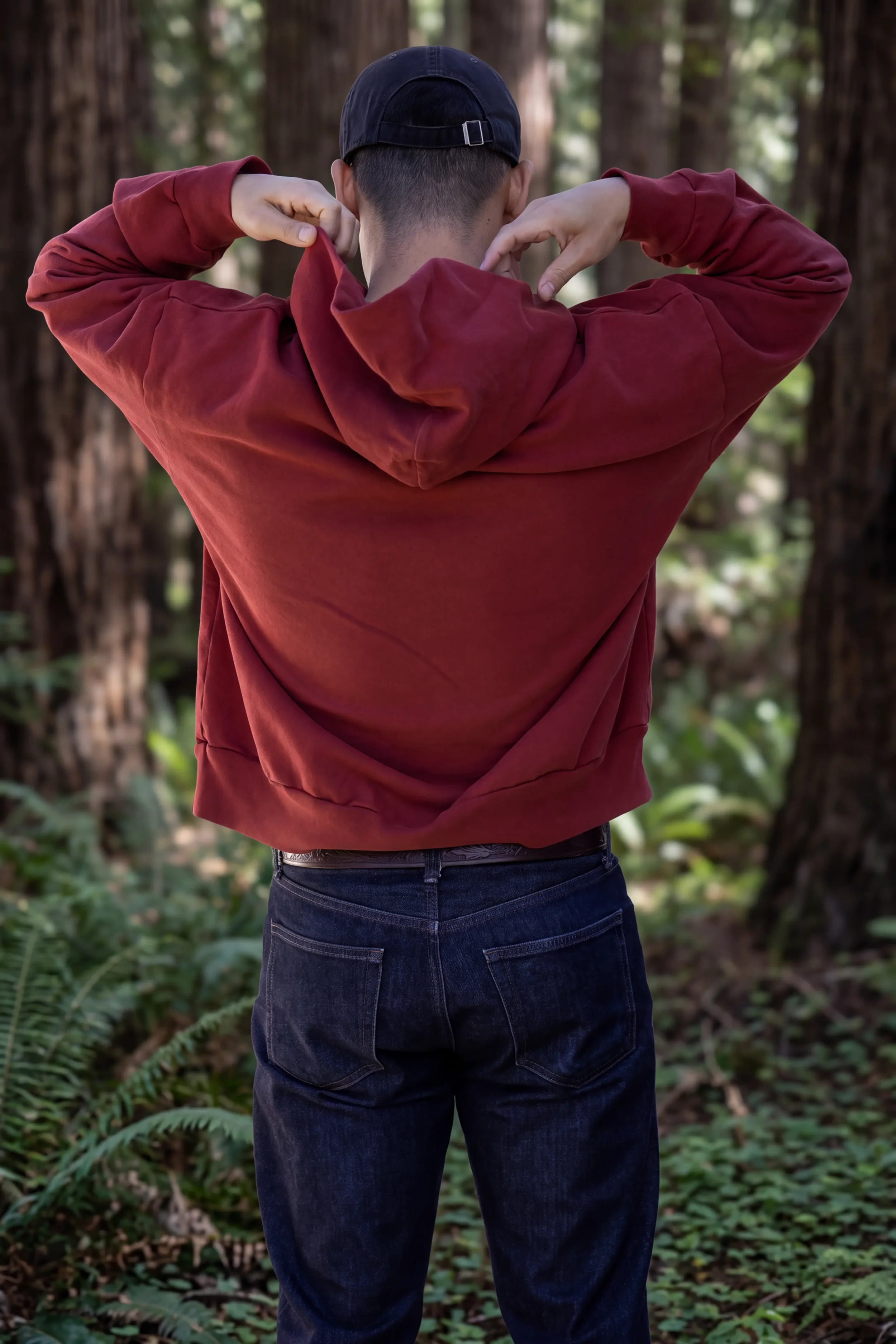 Back view of unprinted ʻŌhelo Red drop-shoulder boxy trash hoodie sitting at the hip by Kekoa Creative.