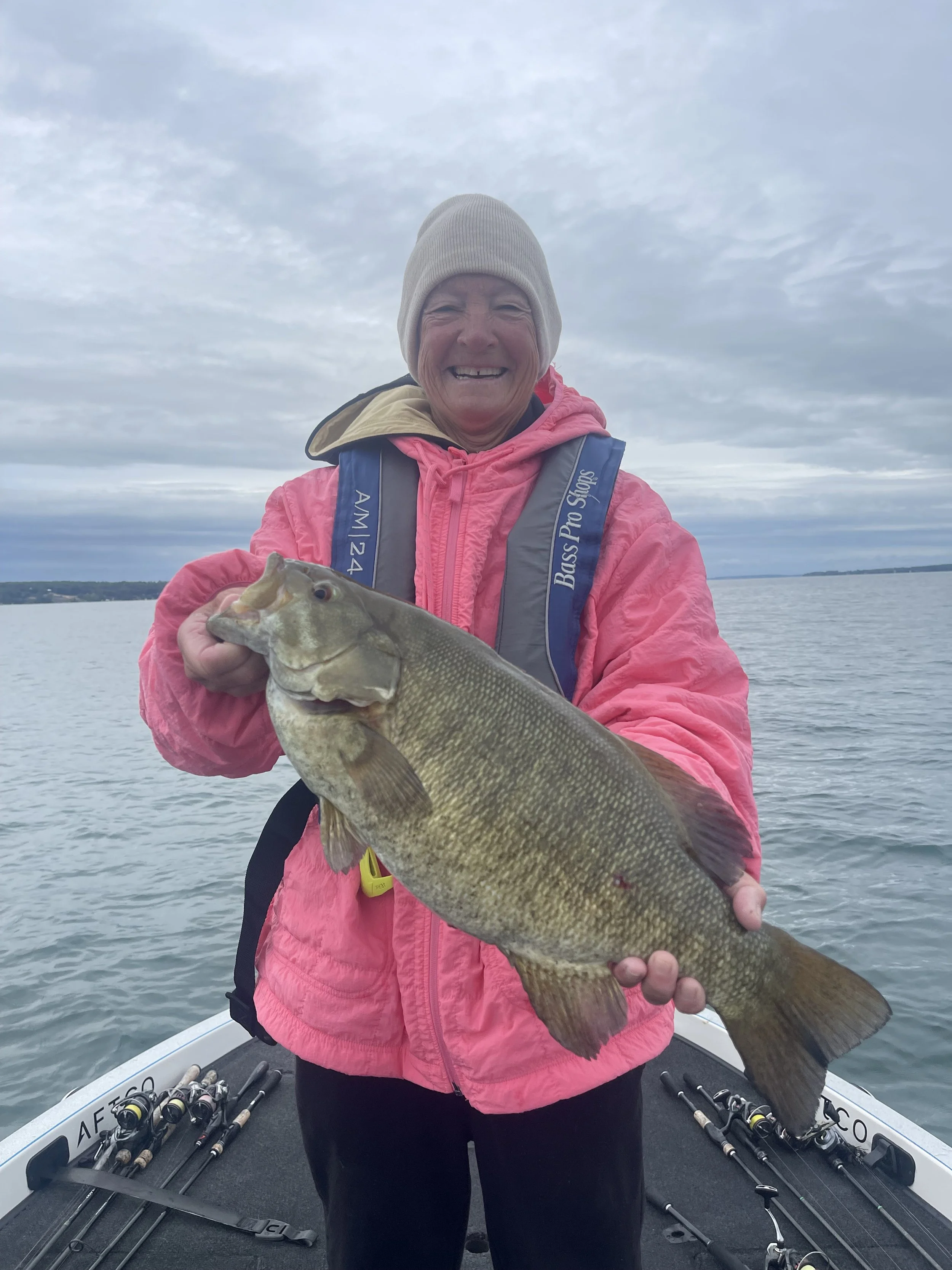 Women Angler poses for picture after catching giant Smallmouth bass 
