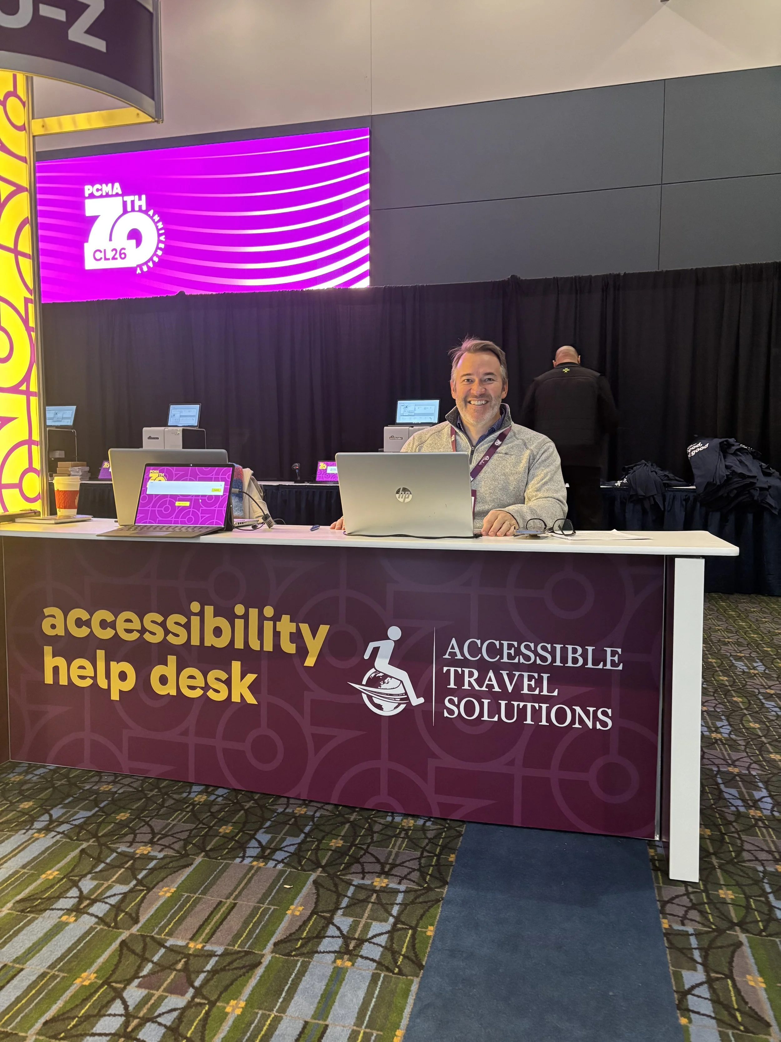 John Sage, founder of Accessible Travel Solutions, staffs an accessibility help desk at PCMA's Convening Leaders 26