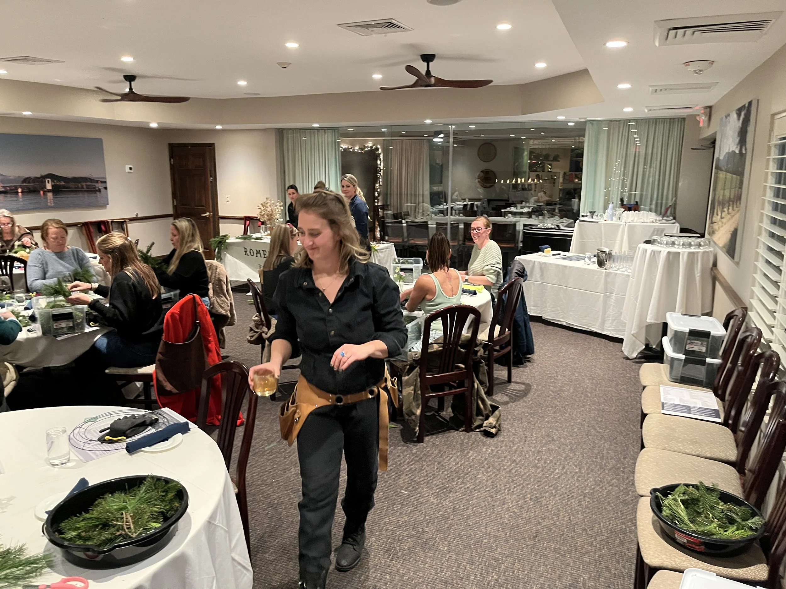 Alex walking through workshop with drink.JPG