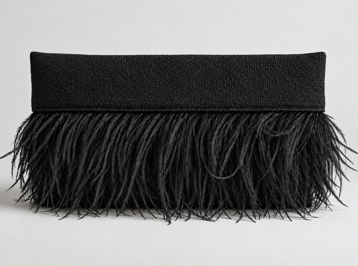 Black pillow with a textured top and feathered fringe design.