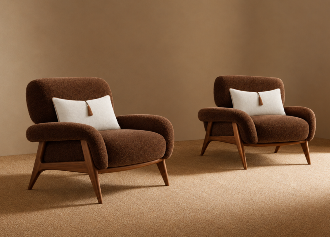 Two brown upholstered armchairs with white pillows and brown tassels, set against a beige wall and tan carpeted floor.