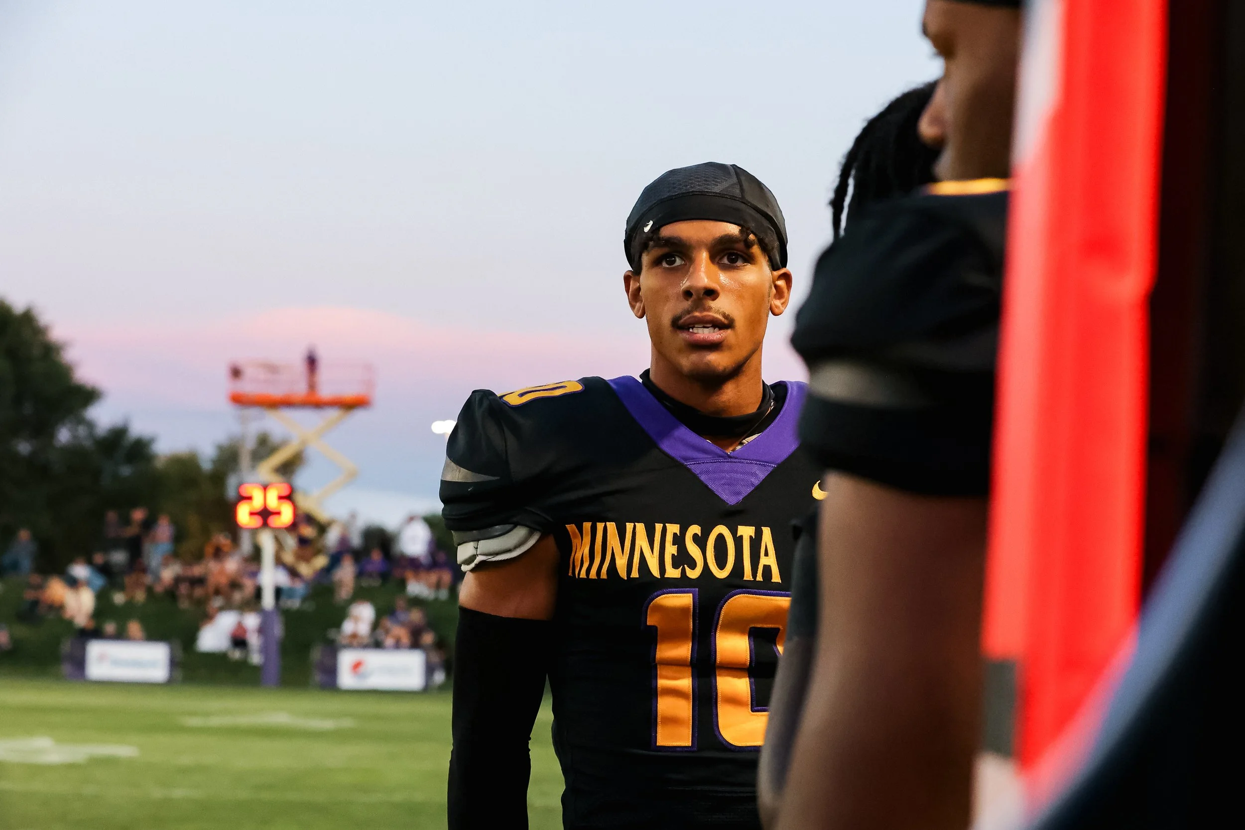 Wide receiver on sideline of football field.jpg