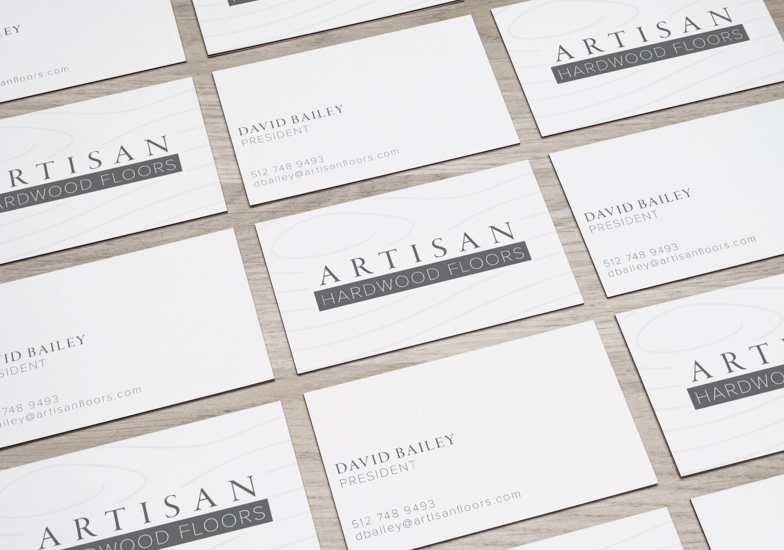Business cards for Artisan Hardwood Floors featuring the company name, logo, and contact information for David Bailey, President.