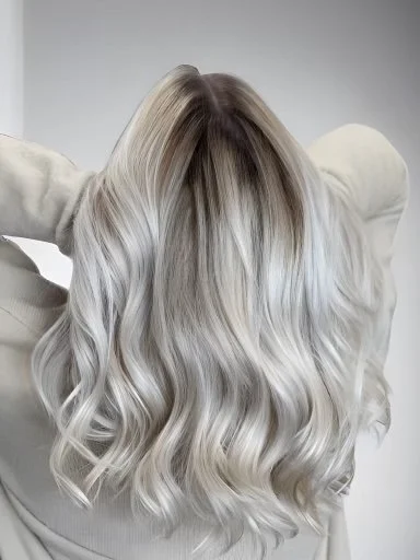 Back view of long platinum-blonde waves with a softly blended darker root.