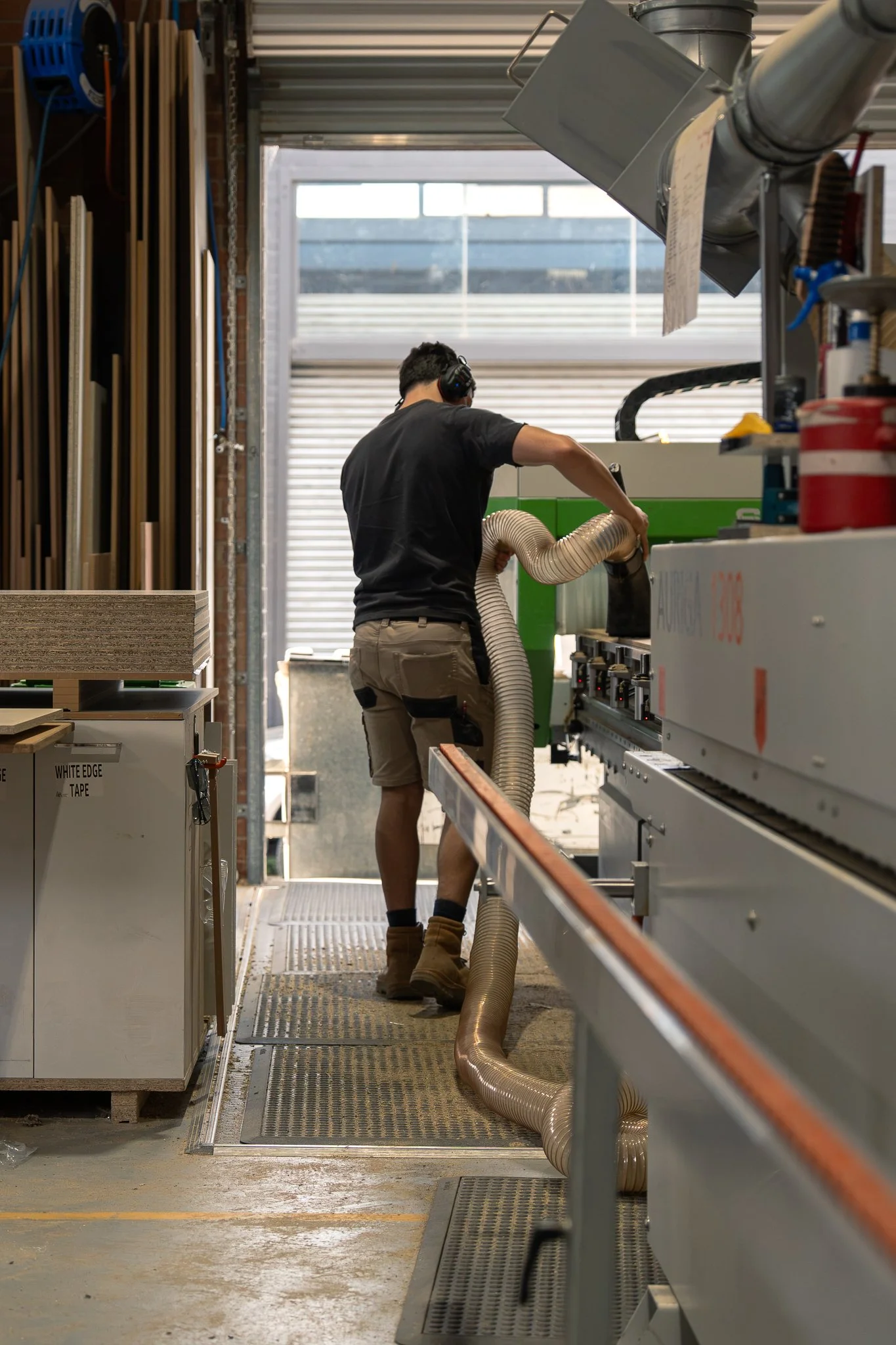 Cabinet maker, cleaning up CNC cutting custom wardrobe and kitchen panels
