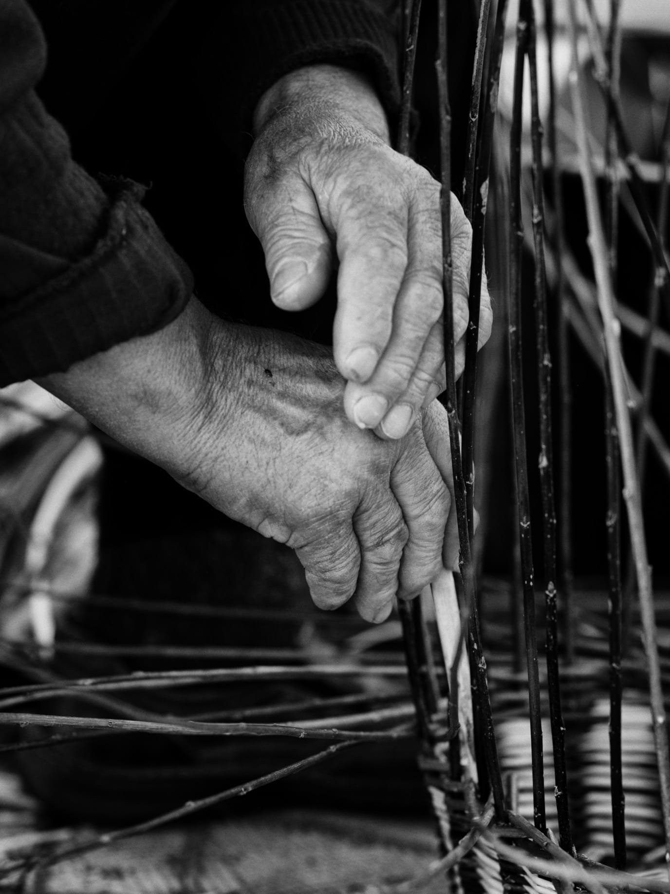  hands of a craftsman creating a basket 