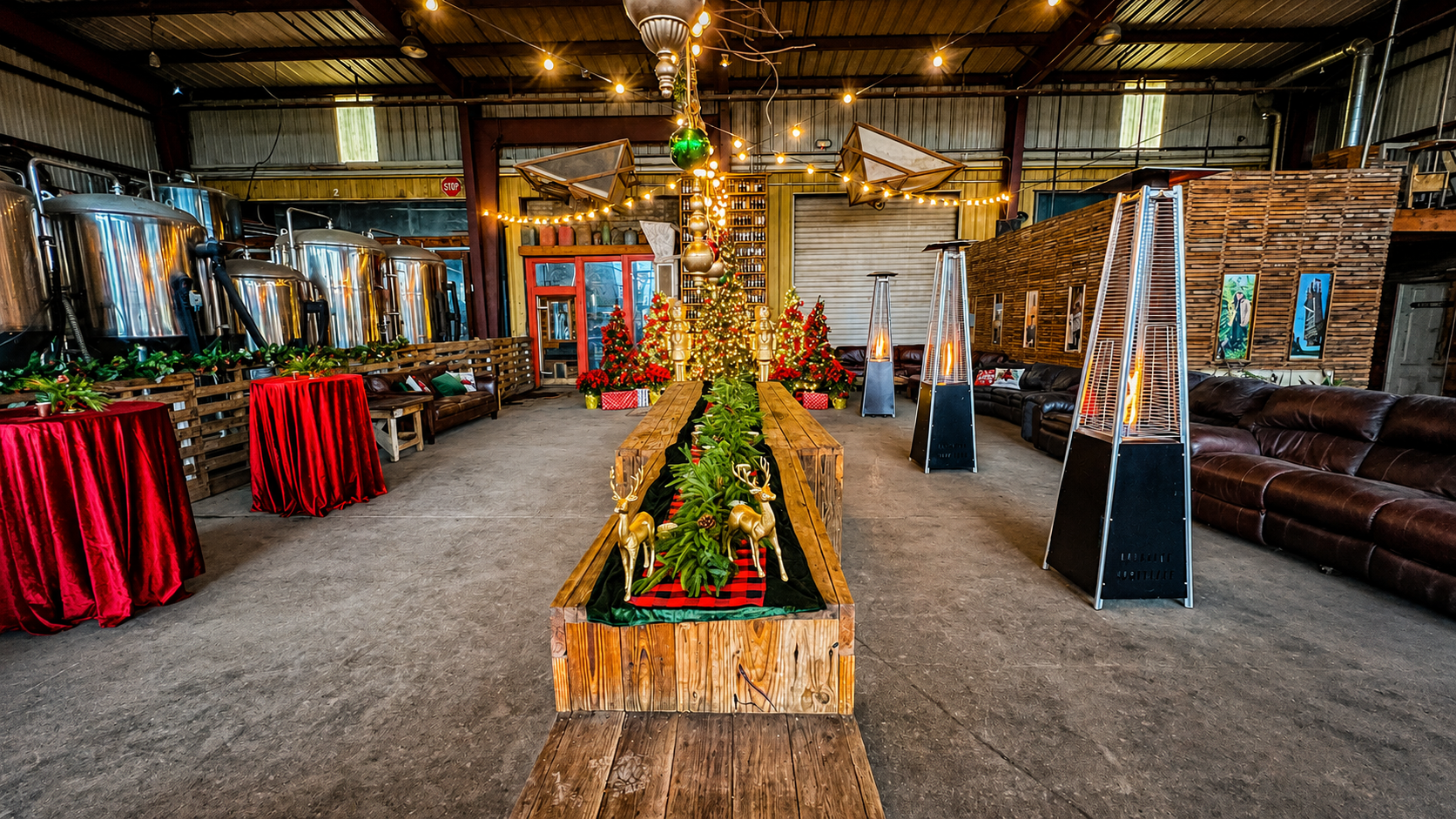 Corporate holiday party venue setup with cocktail tables, lounge seating, heaters, Christmas trees and festive décor.