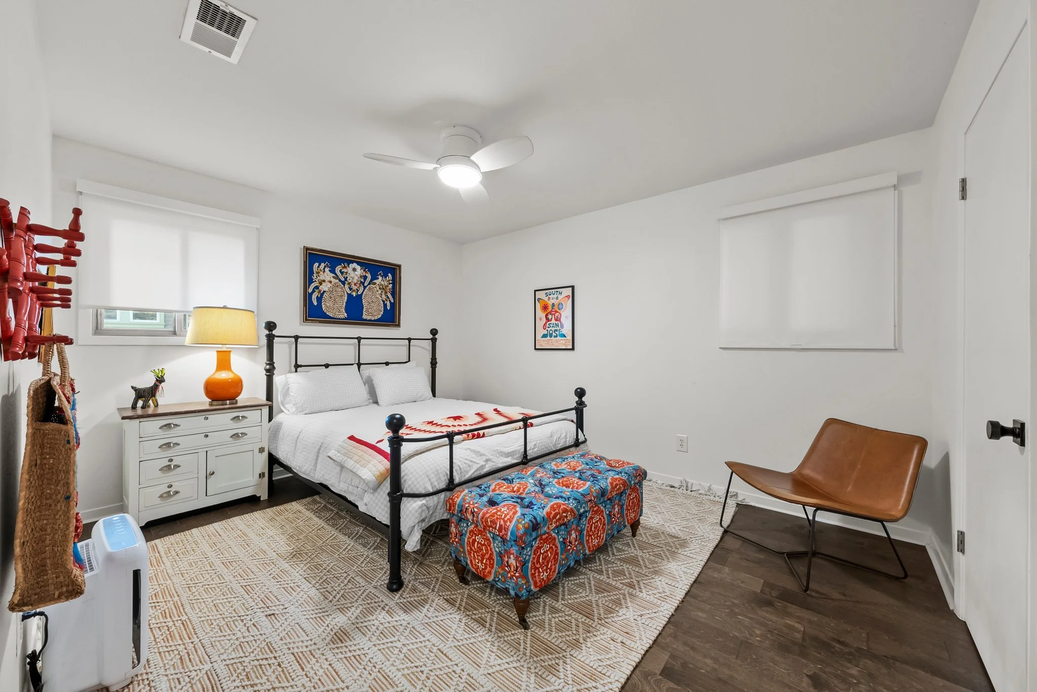 Queen bed, extra pillows and blankets, clothing storage, bed linens, hangers, ceiling fan, air conditioning, room darkening shades