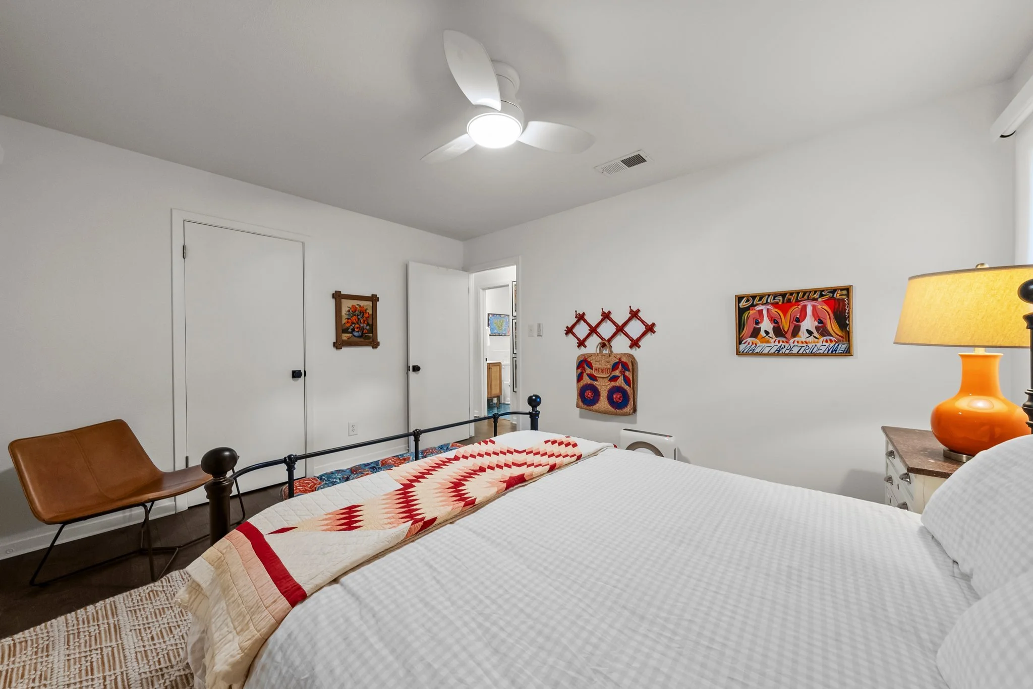 Queen bed, extra pillows and blankets, clothing storage, bed linens, hangers, ceiling fan, air conditioning, room darkening shades