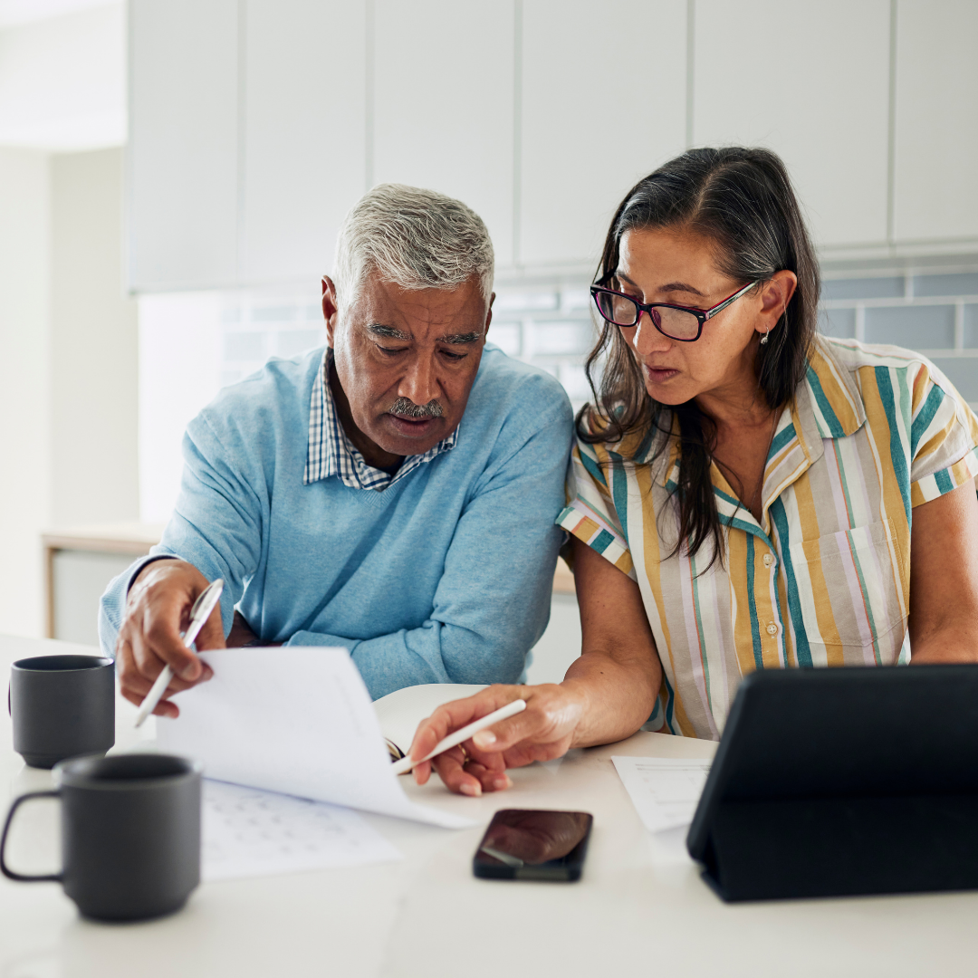 older couple reviewing documents at table