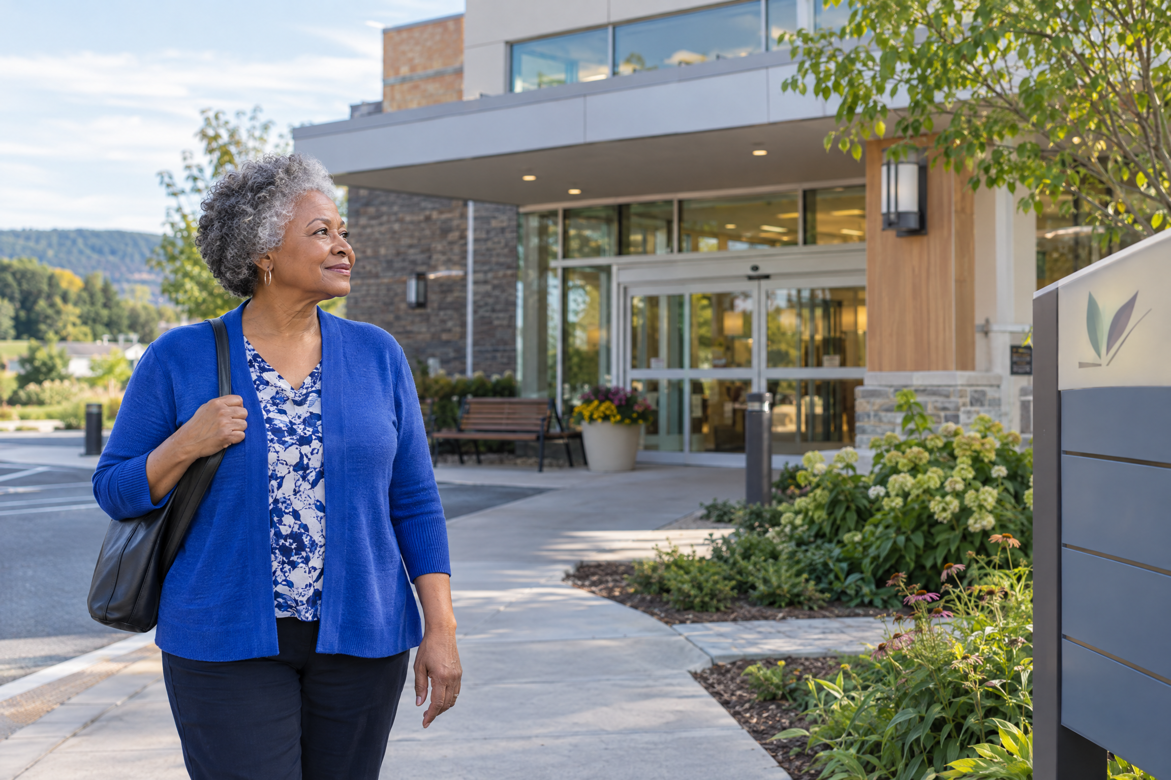Older Black woman outside a Central Pennsylvania medical building while reviewing Medicare plan choices