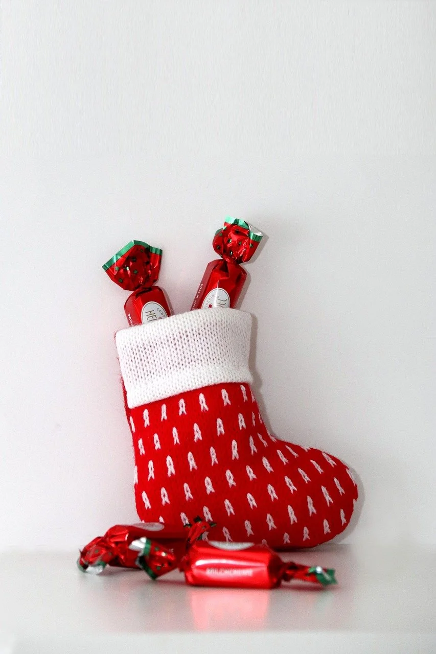 Red Christmas stocking with small treats, stocking stuffers for kids