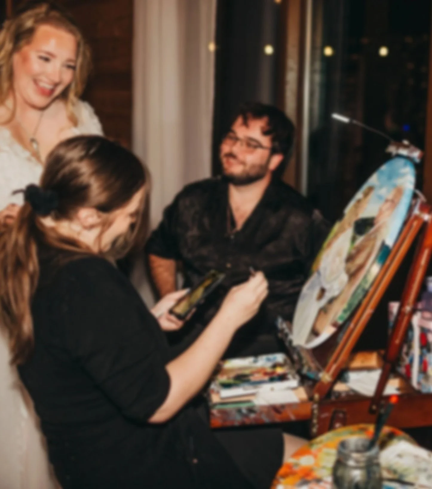 A wedding painter at work on a live wedding painting as a virginia artist
