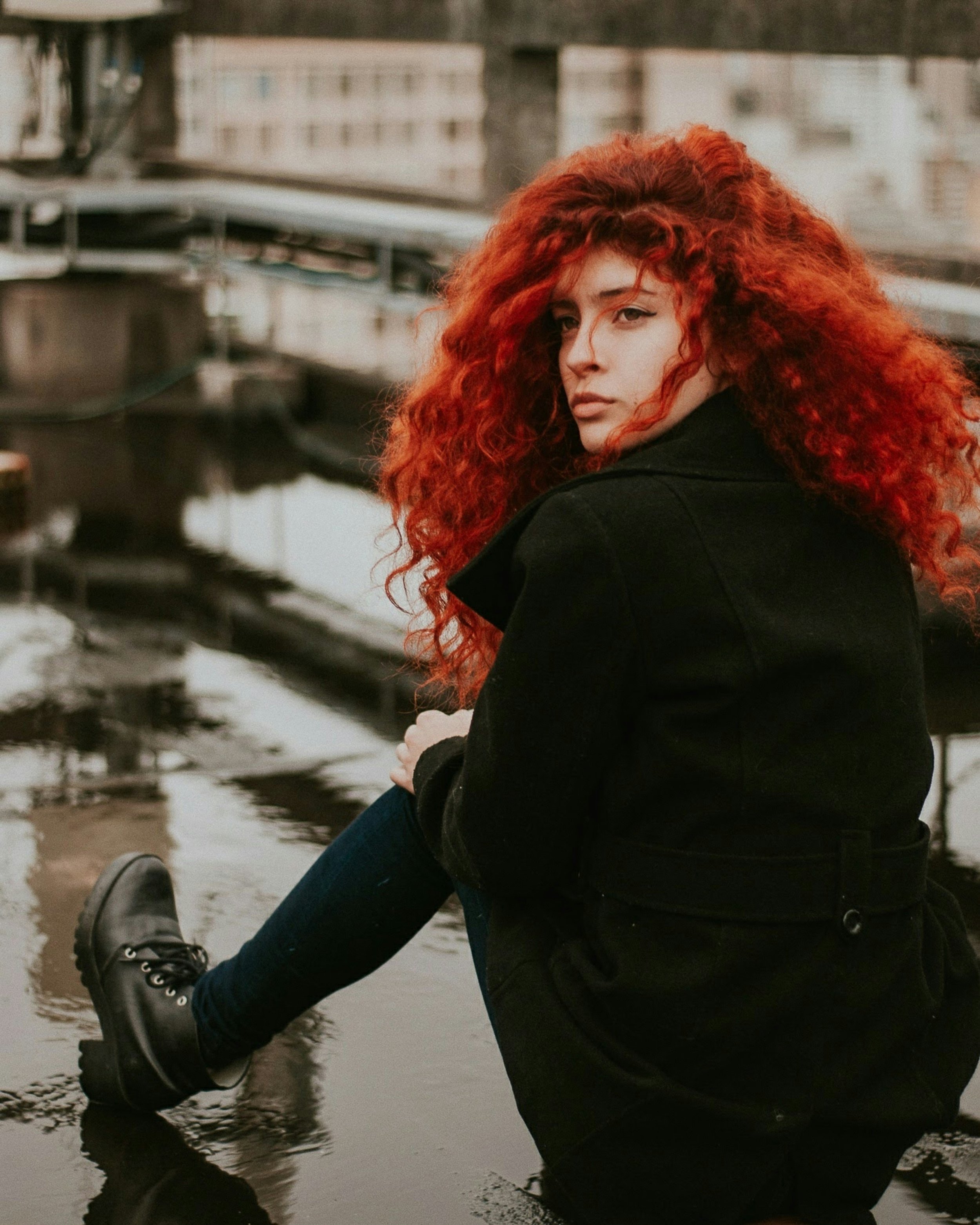 Rebellious woman with red hair and black jacket for sober October