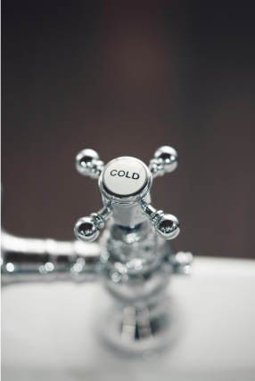 Shower faucet showing the word "cold"