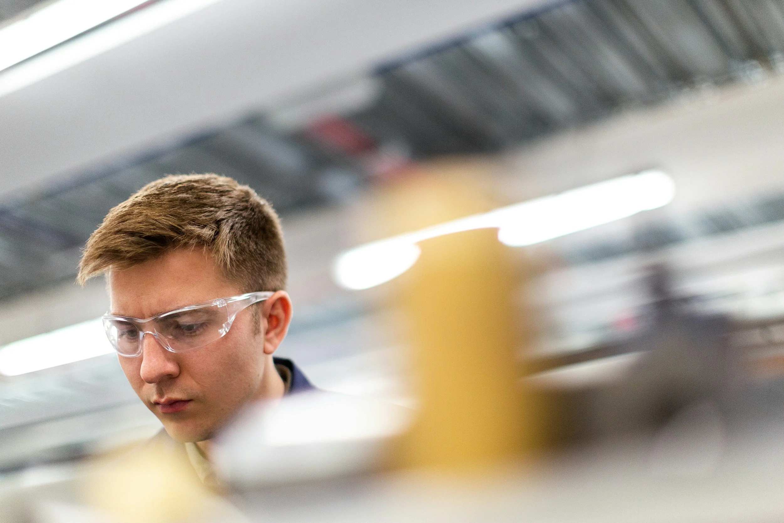 High school student in safety goggles during a chemistry lab