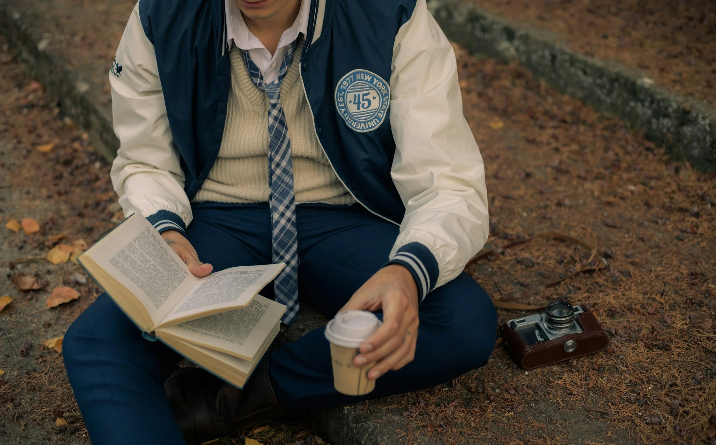 Student in a school uniform reading, preparing for private school admissions