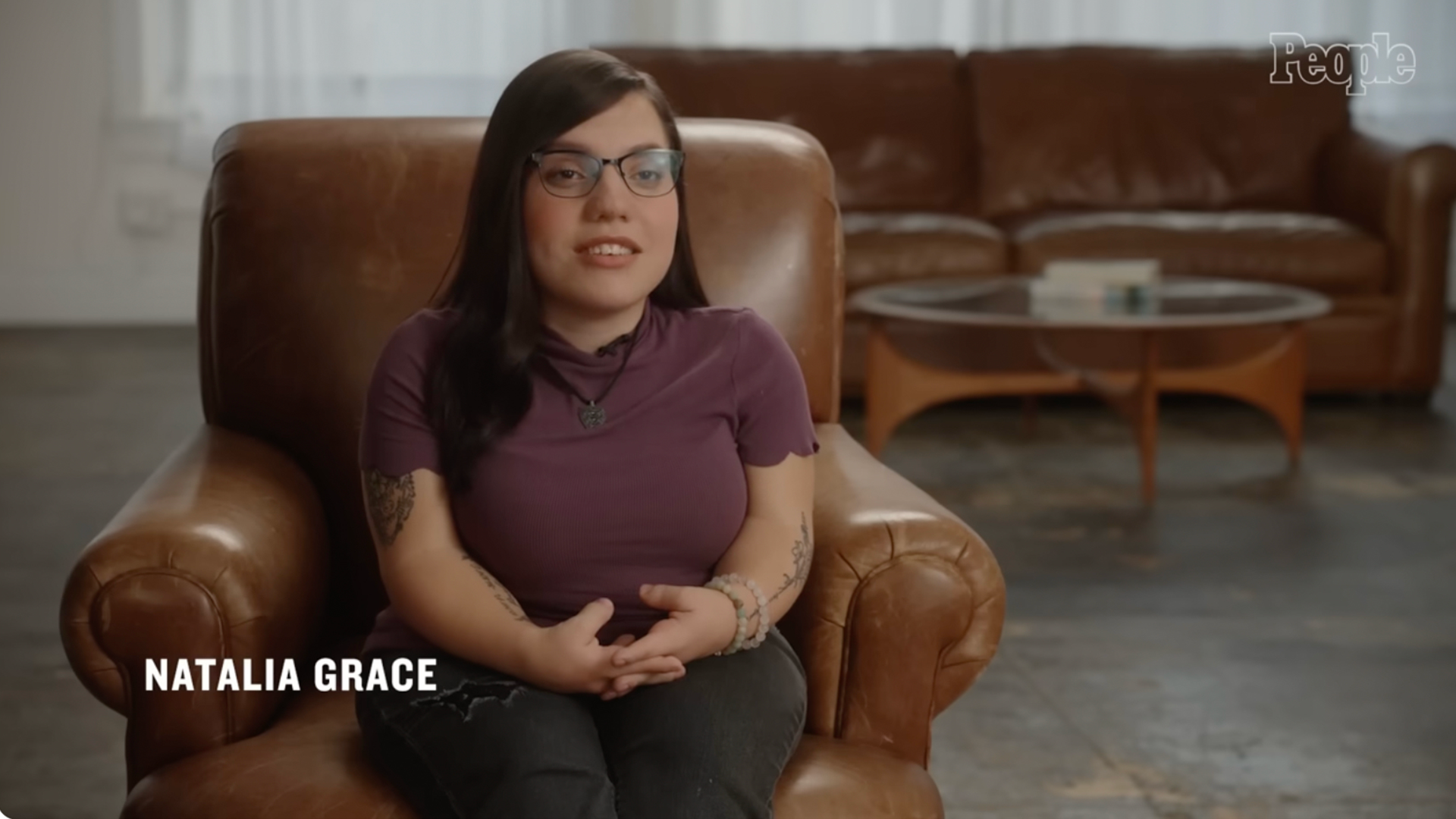 Natalia Grace speaks during a sit-down interview while seated in a brown leather armchair.