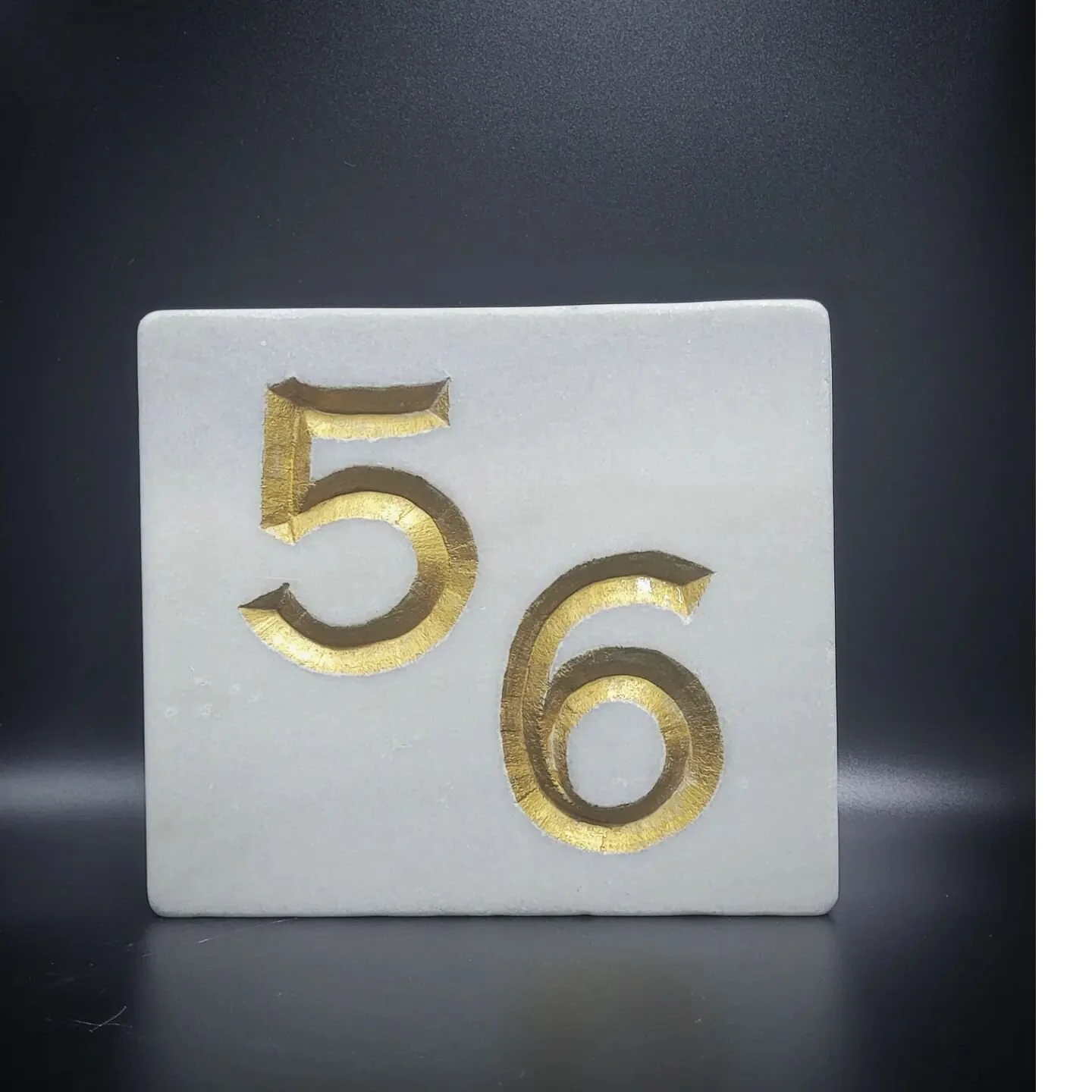 House number carved into italian marble .finished with gold leaf gilding.#stonecarving #stonecraft #natural #gilding #housenumbers #housenumber #number #customhomes #customhome #italy #italianmarble #marble #stonemasonry #stonemasons #stonemason #hou