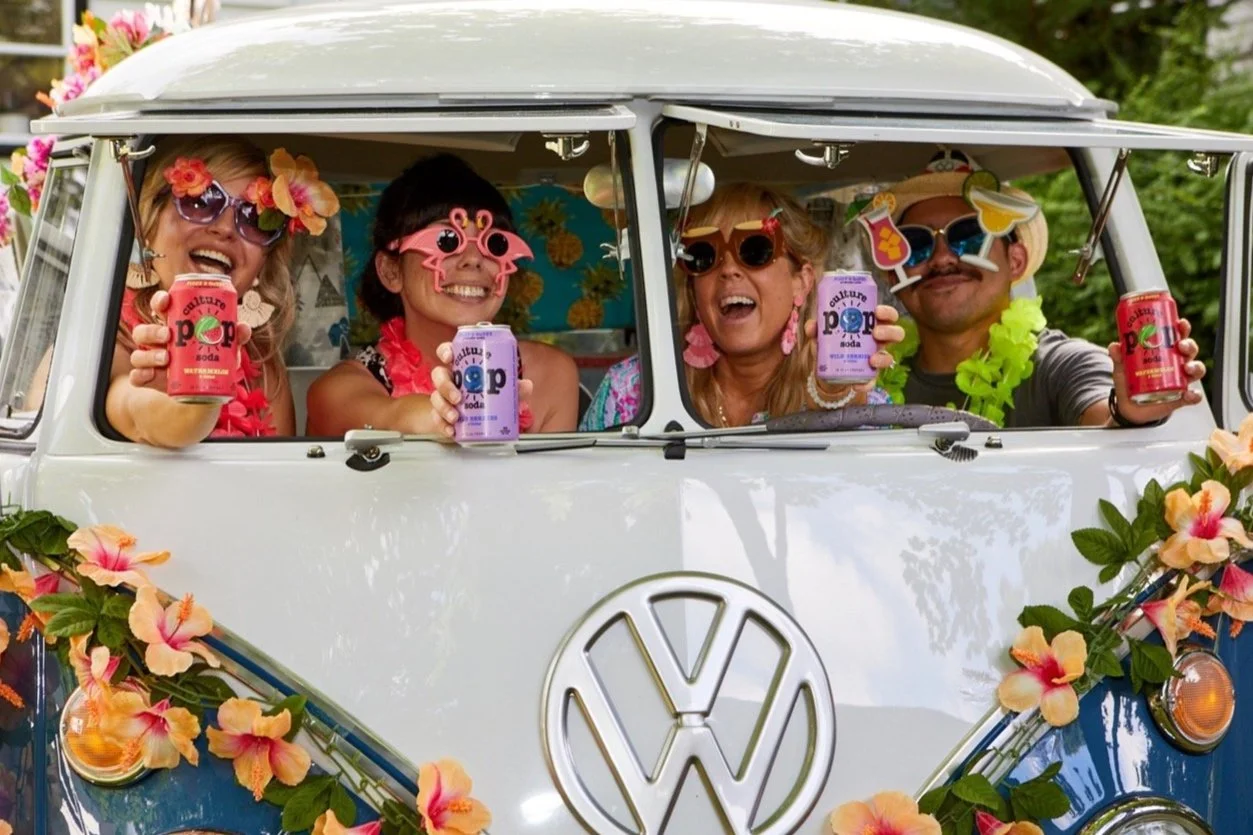 Four People Smiling in VW Photo bus
