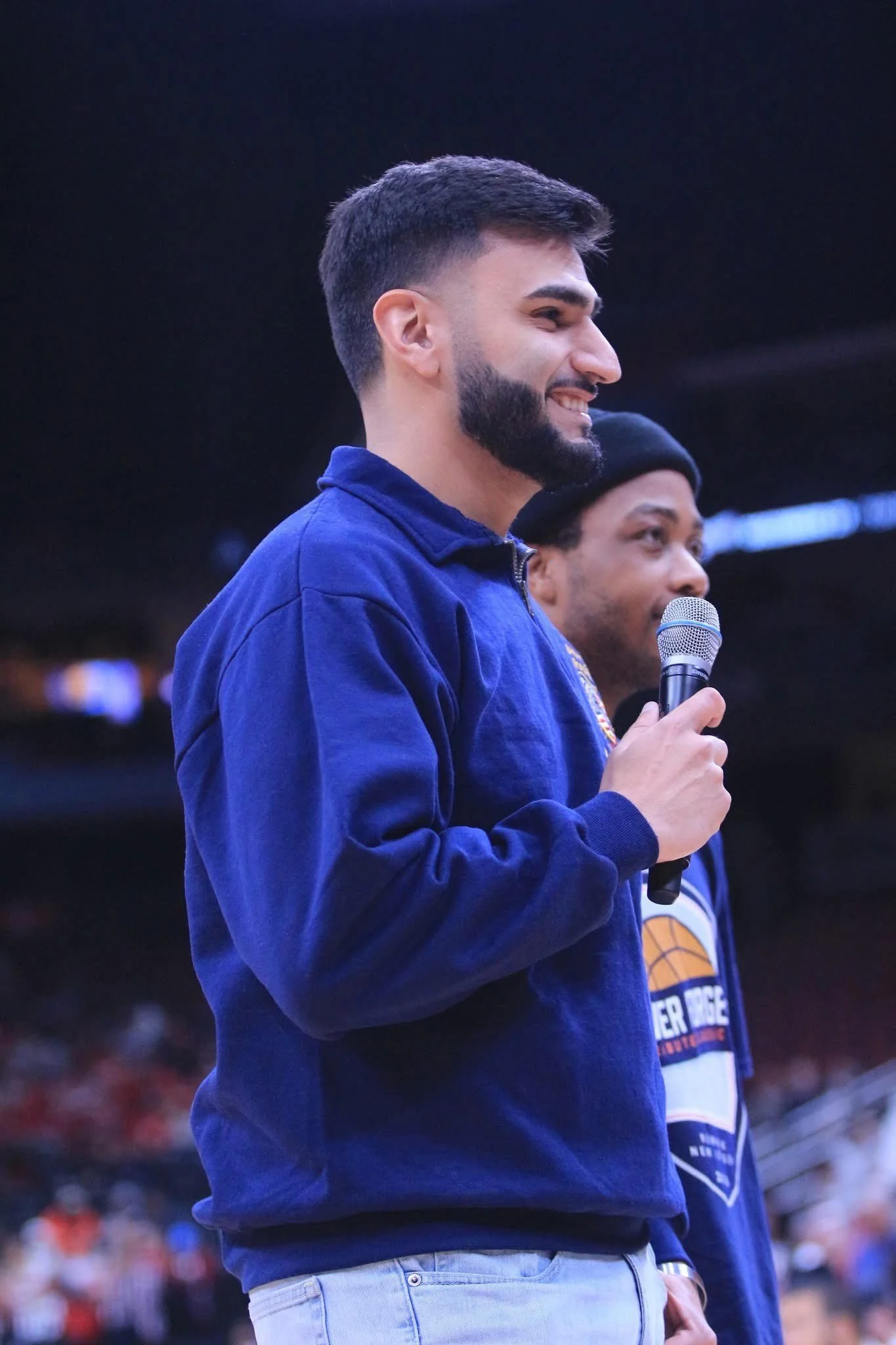 Jayden Becker, professional live event host and on-air talent, holding a microphone during a live event