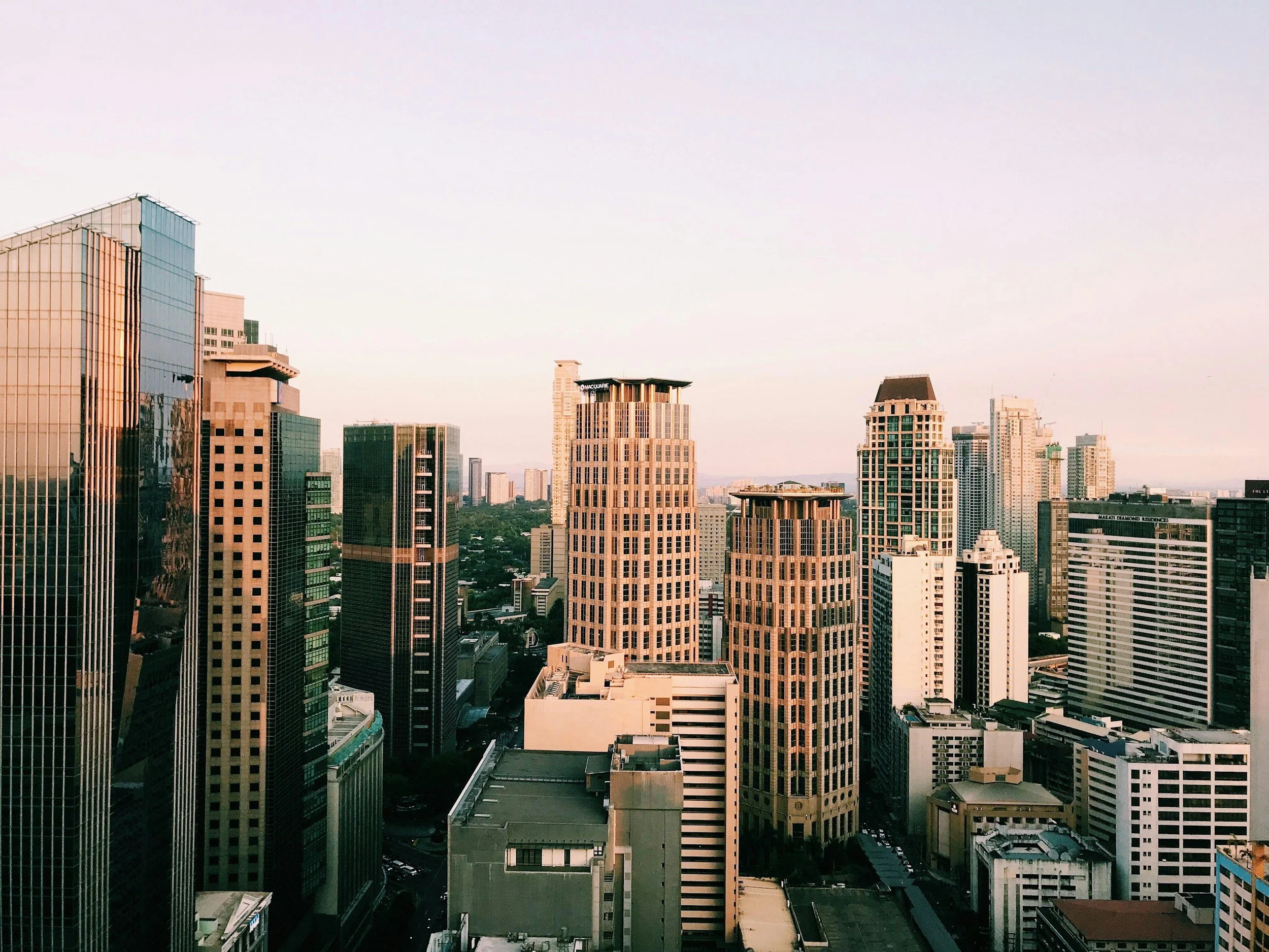 City skyline with tall modern buildings under a clear sky.