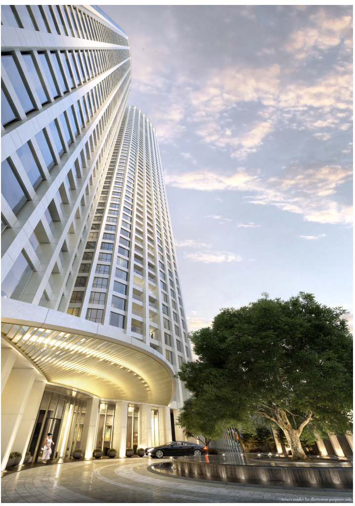 Tall modern skyscraper with glass windows, a large tree, and a circular entrance lit with warm lights at sunset.