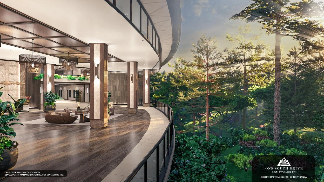A modern balcony with a wooden floor, furniture, and greenery overlooking a forested area with tall trees at sunset.
