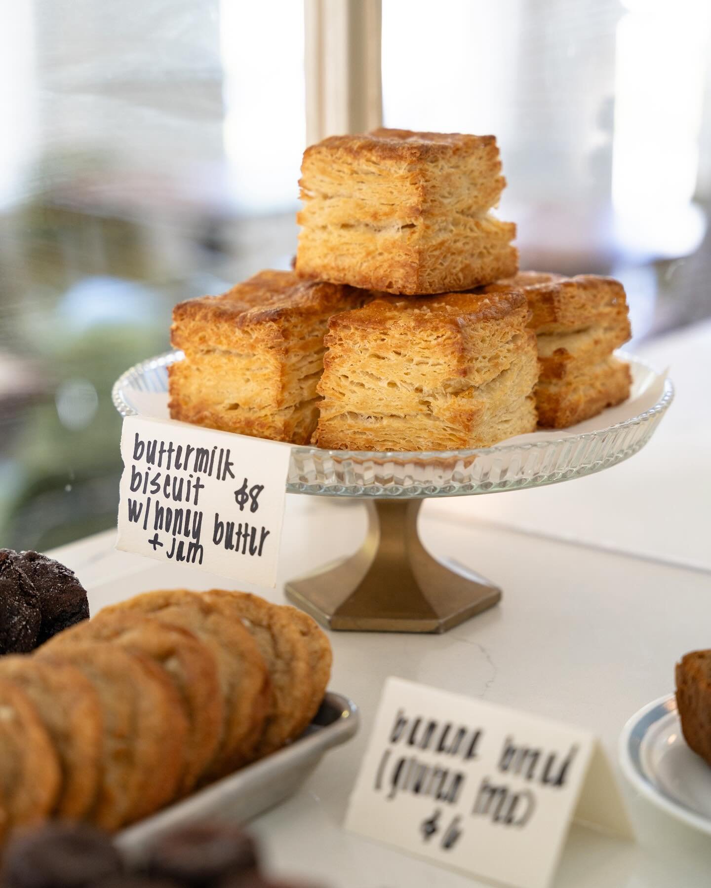 The all mighty buttermilk biscuit, served with honey butter and raspberry vanilla jam. Y&rsquo;all give it up for @bootscootinbread and her wrists, she&rsquo;s working them to the bone to get all those layers!! Open today 9A-3P.