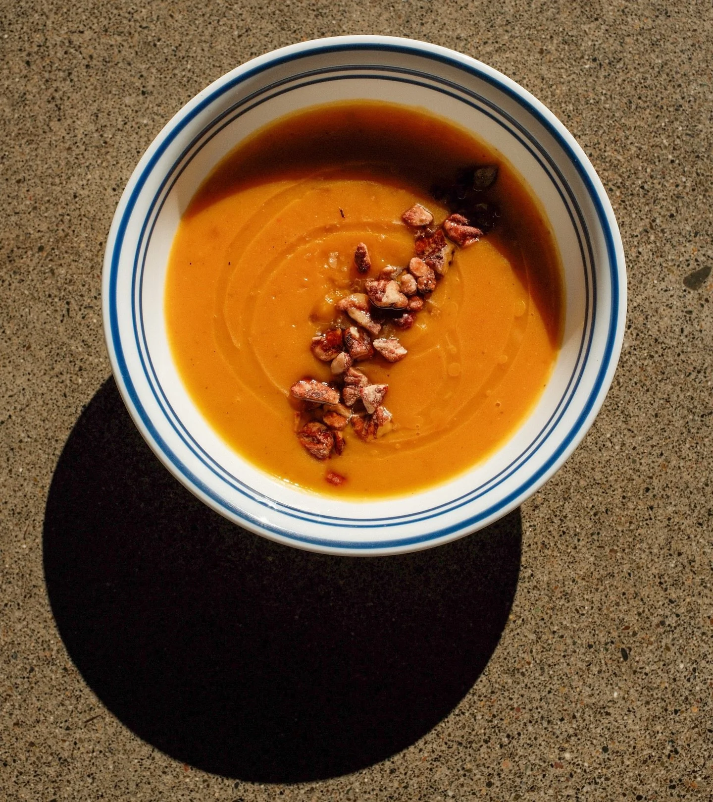 Curry Butternut Squash with Toasted Pecan.
Smooth and creamy, this vegan soup has Madras curry, coconut milk and a touch of Aleppo chili, topped with toasted pecans - it will warm you from the inside out! 
Add toast if you wish.