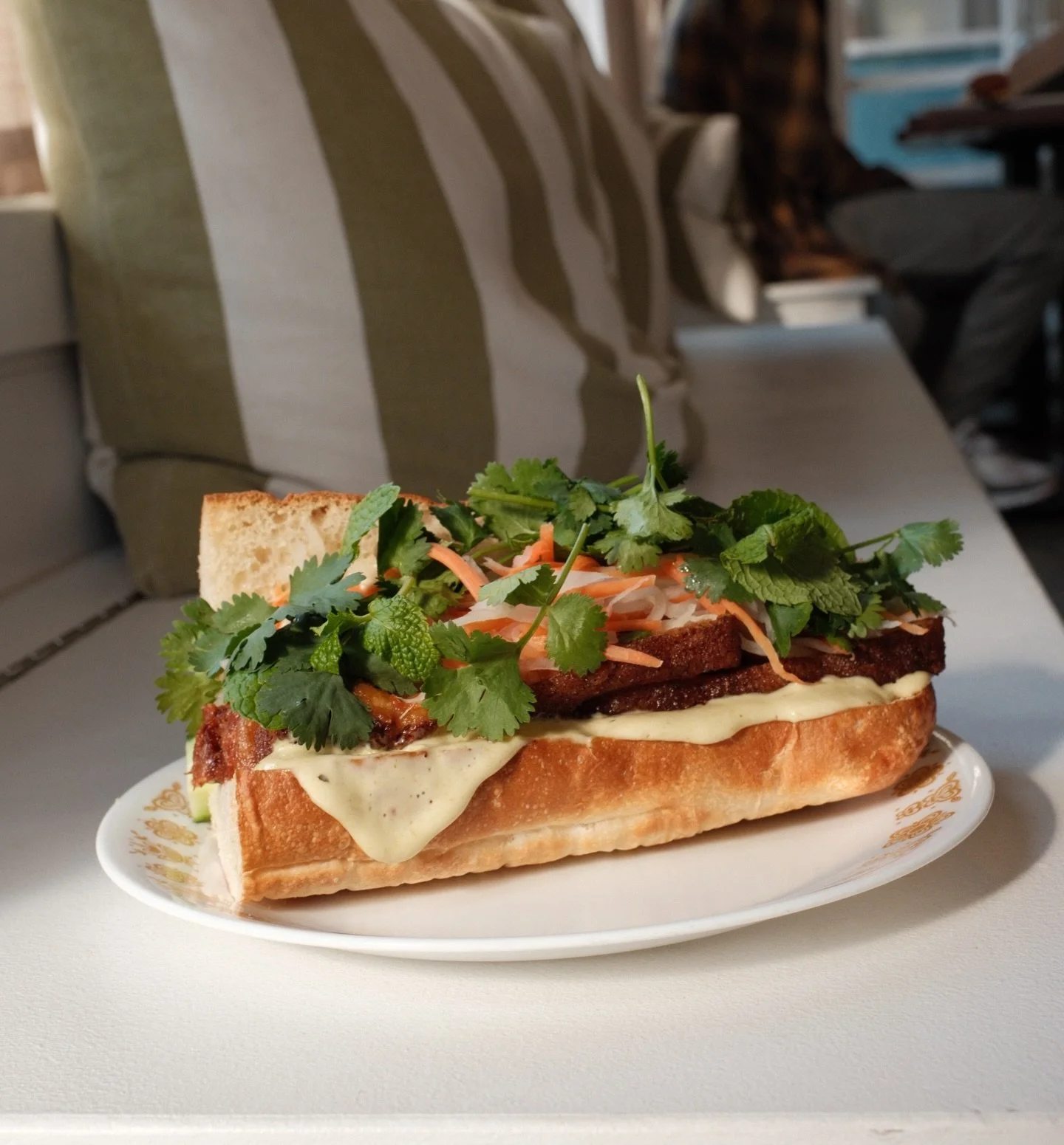 Have you tried our Peace, Love &amp; Pork Belly yet?! Tender slow roasted Carlton Farms pork belly and spicy jalape&ntilde;o aioli with fresh cilantro, mint, cucumber, pickled daikon and carrot that cut through the richness creating harmonious bite a