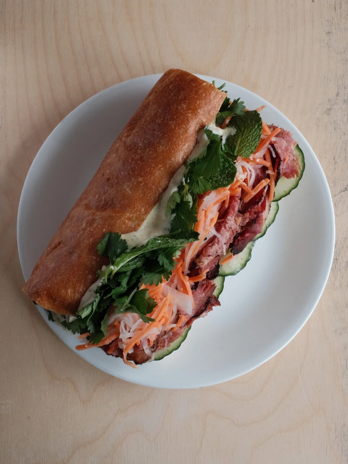 ☮️ Peace, Love &amp; Pastrami - this sandwich screams texture and flavor. 
❤️ Inspired by a banh mi, filled with crisp pickled carrot and daikon, fresh mint and cilantro, a little kick with jalape&ntilde;o aioli and peppery smoked brisket, all on a t