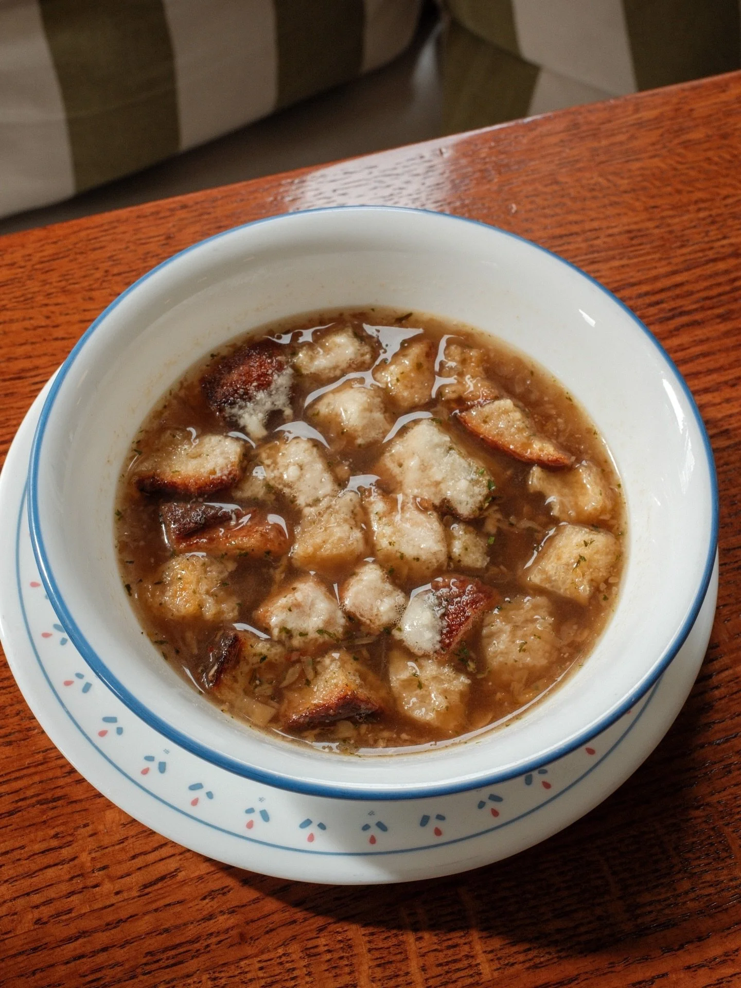 Imagine a cozy little bowl that&rsquo;s basically the onion&rsquo;s version of a spa day&mdash;layers of caramelized onions lounging in a rich, savory broth, all topped with a golden crown of melted Parmesan and croutons. Every spoonful, a warm hug&h