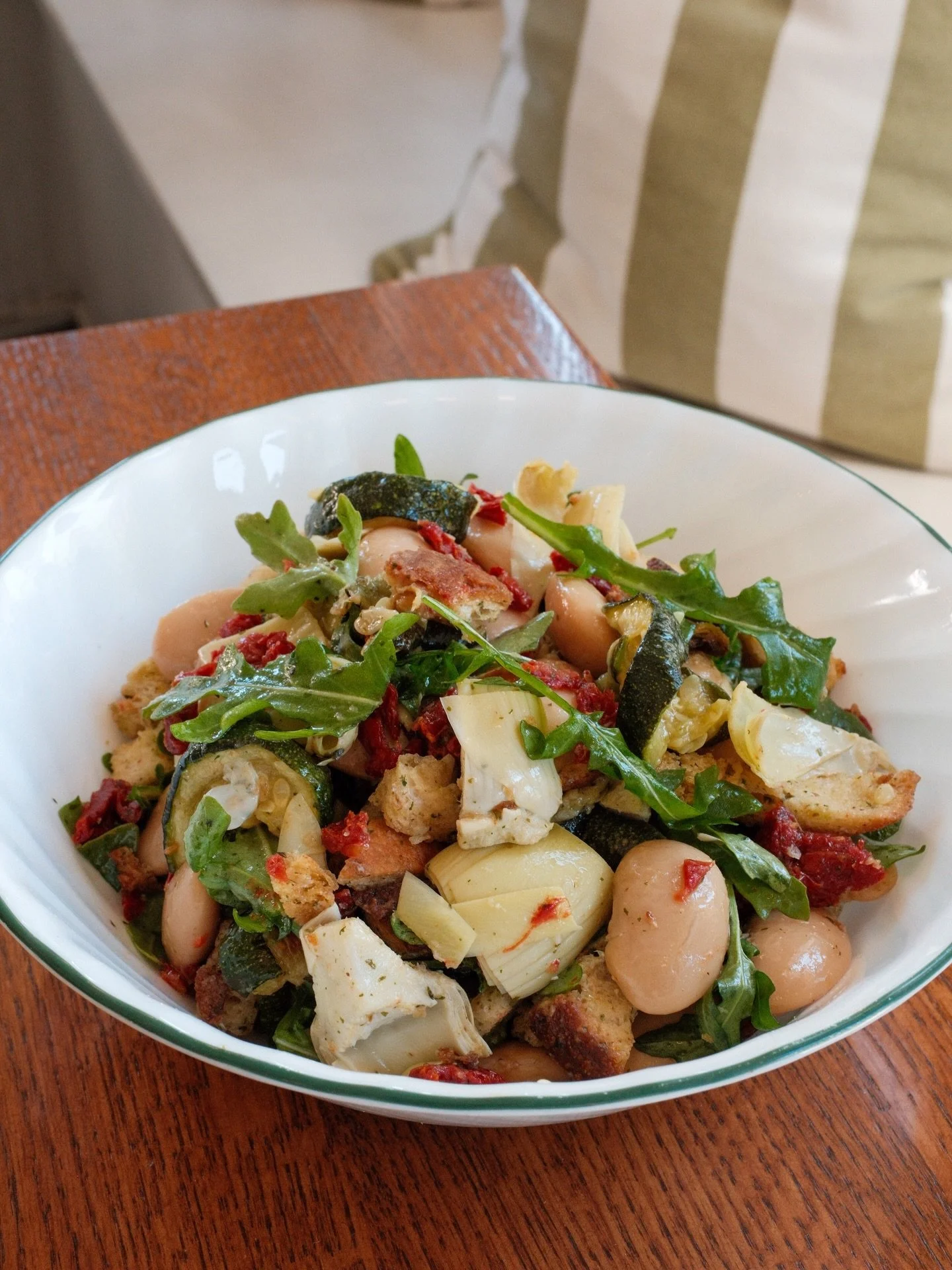 We call it Mr. Bean, not because it&rsquo;s a bean salad, but because the beans are big, creamy and a focal point to the salad.  Marinated gigante beans, artichoke, roasted summer squash, sun-dried tomato, arugula, croutons and spring onion vinaigret