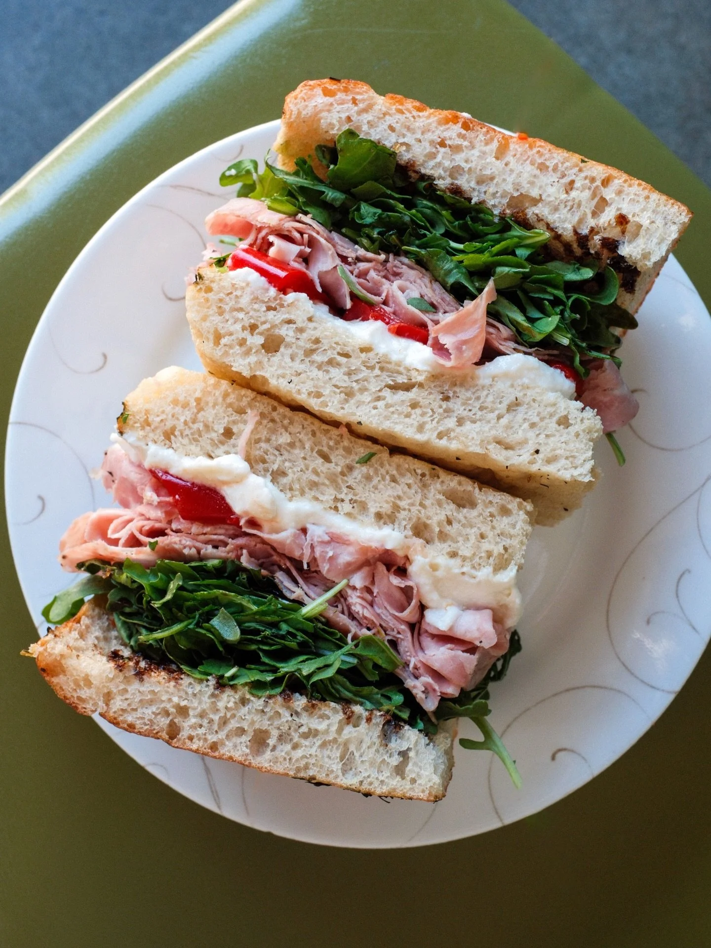 Nothing can compare to @eatframani salame Rosa studded with pistachio and draped on warm herby focaccia with Parmesan cream, pickled goat horn peppers, arugula and balsamic.  THE quintessential picnic sandwich of our summer menu. #mortadellashiddenbr