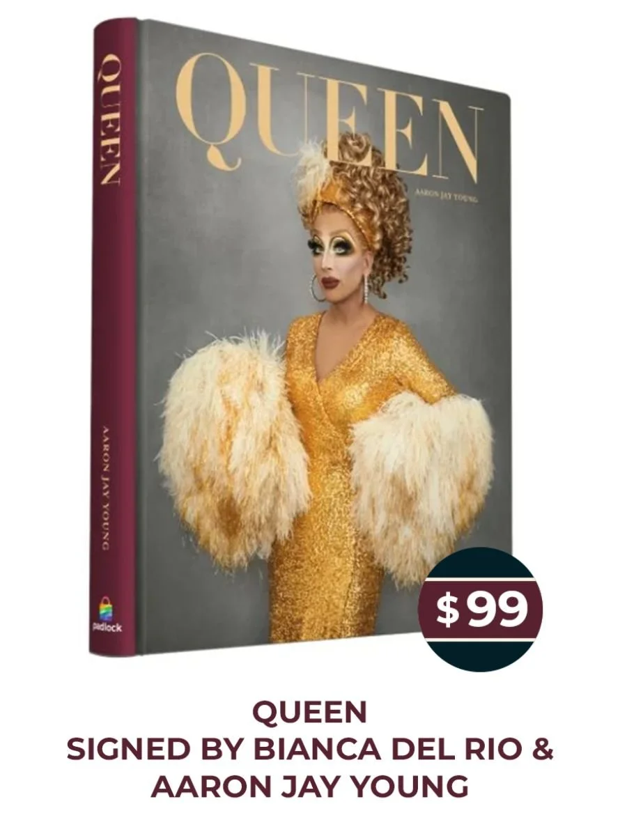 Book titled "Queen" featuring Bianca Del Rio on cover, dressed in a gold sequined gown with large feathered sleeves and a headpiece, priced at $99, signed by Bianca Del Rio and Aaron Jay Young.