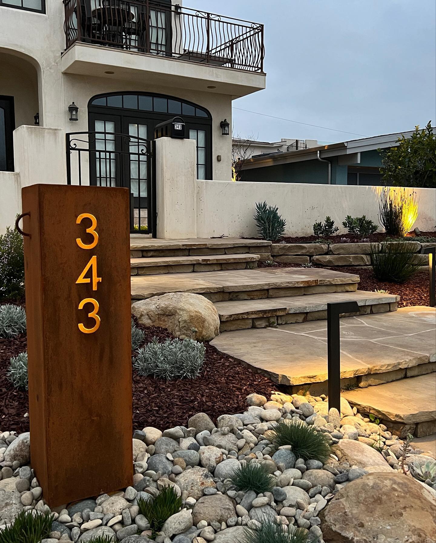 Keiper Landscape Renovation: Elevate your front yard with our high-end landscaping design featuring custom lights and metal work. The combination of premium materials and expert craftsmanship creates a stunning display that will impress all who pass 