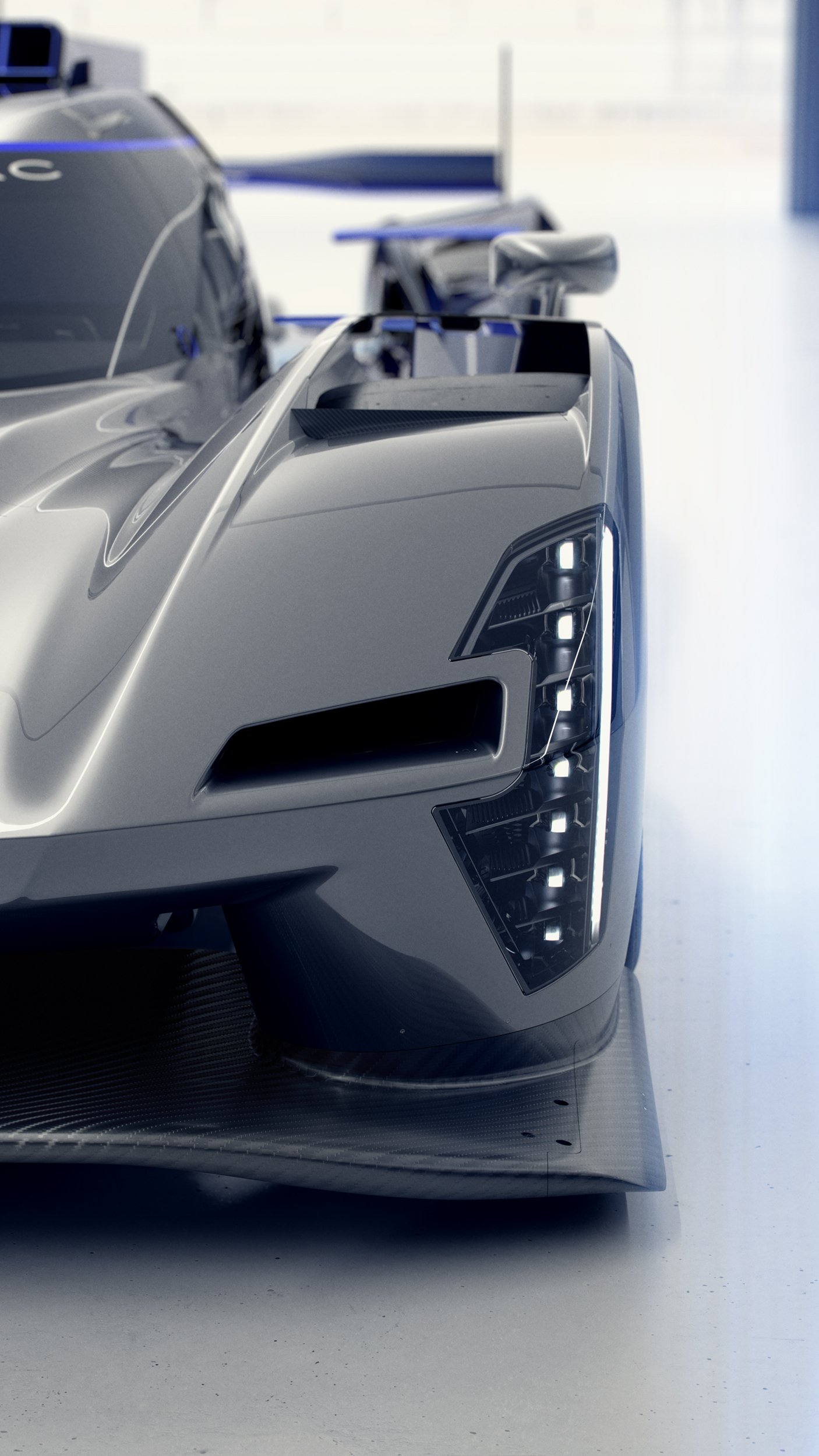 Photorealistic CGI render of a silver and blue Cadillac V-Series.R race car, showcasing high-end automotive visualisation, lighting, and post-production retouching.