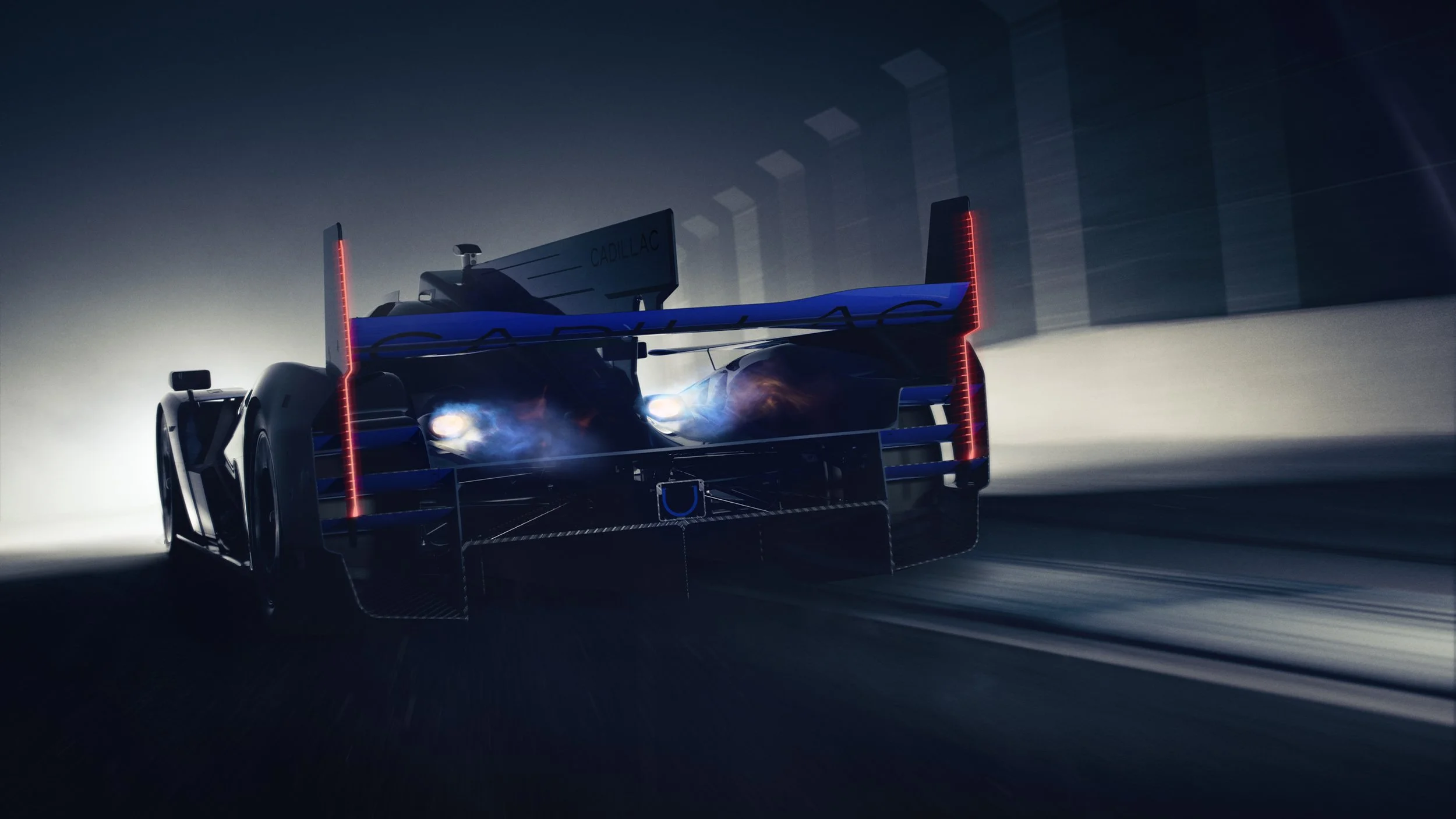 Photorealistic CGI render of a silver and blue Cadillac V-Series.R race car on a race track at night.