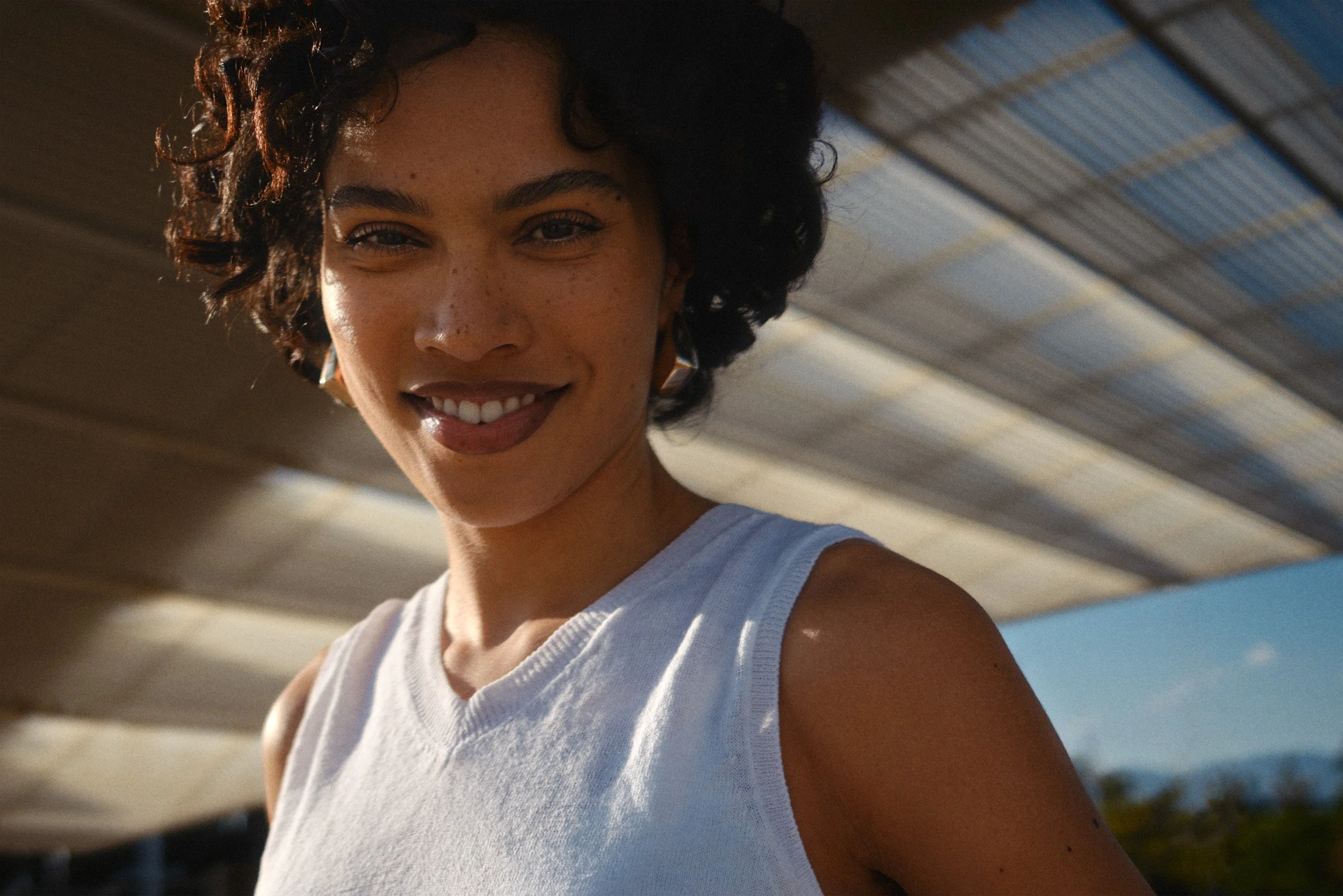 Automotive advertising image of woman on steps with Lancia Ypsilon. Automotive photography, CGI, retouching, postproduction