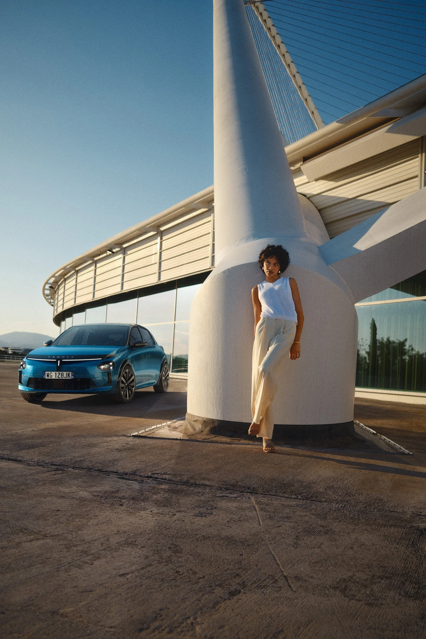 Automotive advertising image of woman on steps with Lancia Ypsilon. Automotive photography, CGI, retouching, postproduction