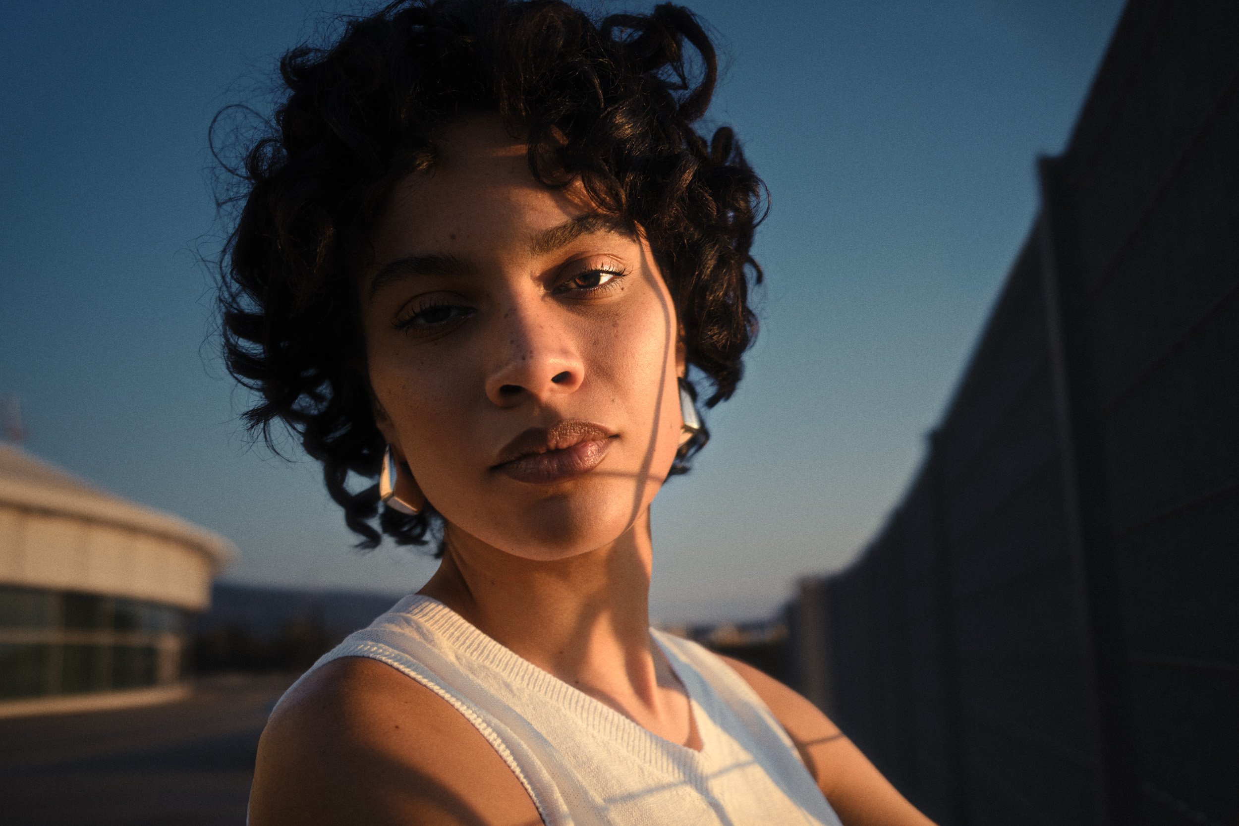 Automotive advertising image of woman on steps with Lancia Ypsilon. Automotive photography, CGI, retouching, postproduction, lifestyle