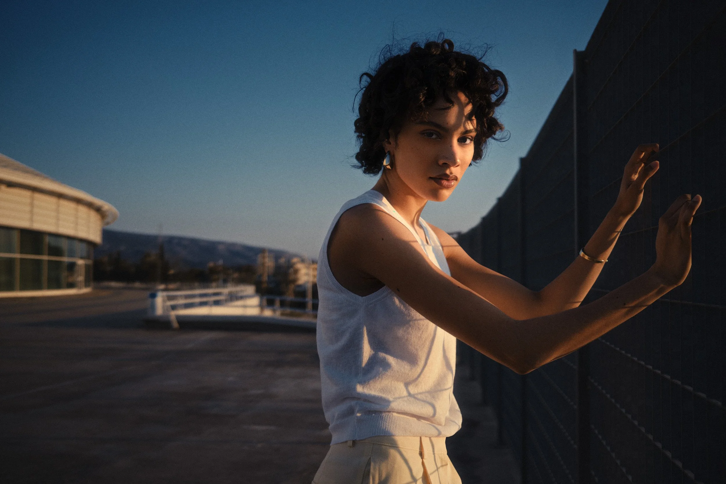 Automotive advertising image of woman on steps with Lancia Ypsilon. Automotive photography, CGI, retouching, postproduction, lifestyle