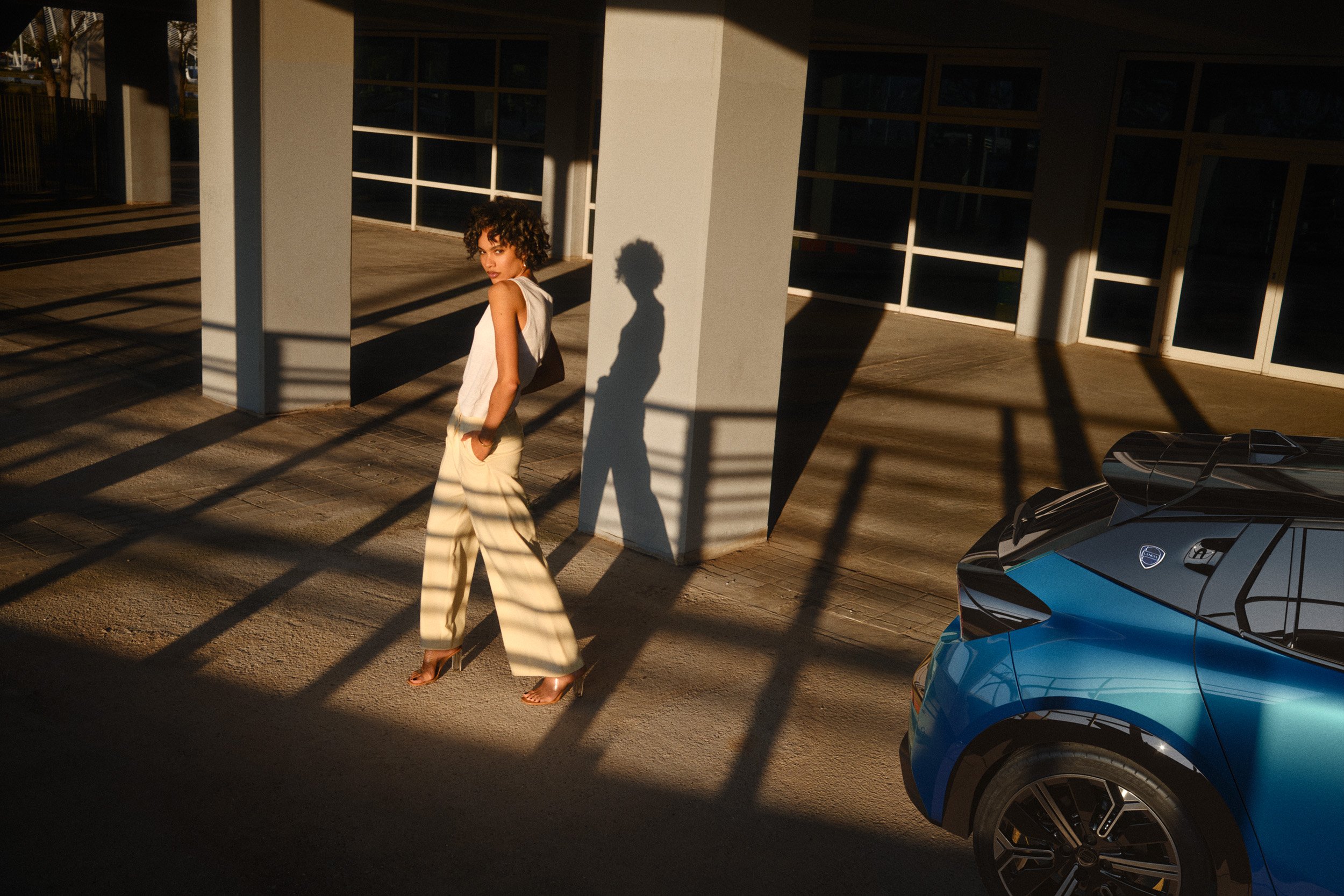 Automotive advertising image of woman on steps with Lancia Ypsilon. Automotive photography, CGI, retouching, postproduction, lifestyle