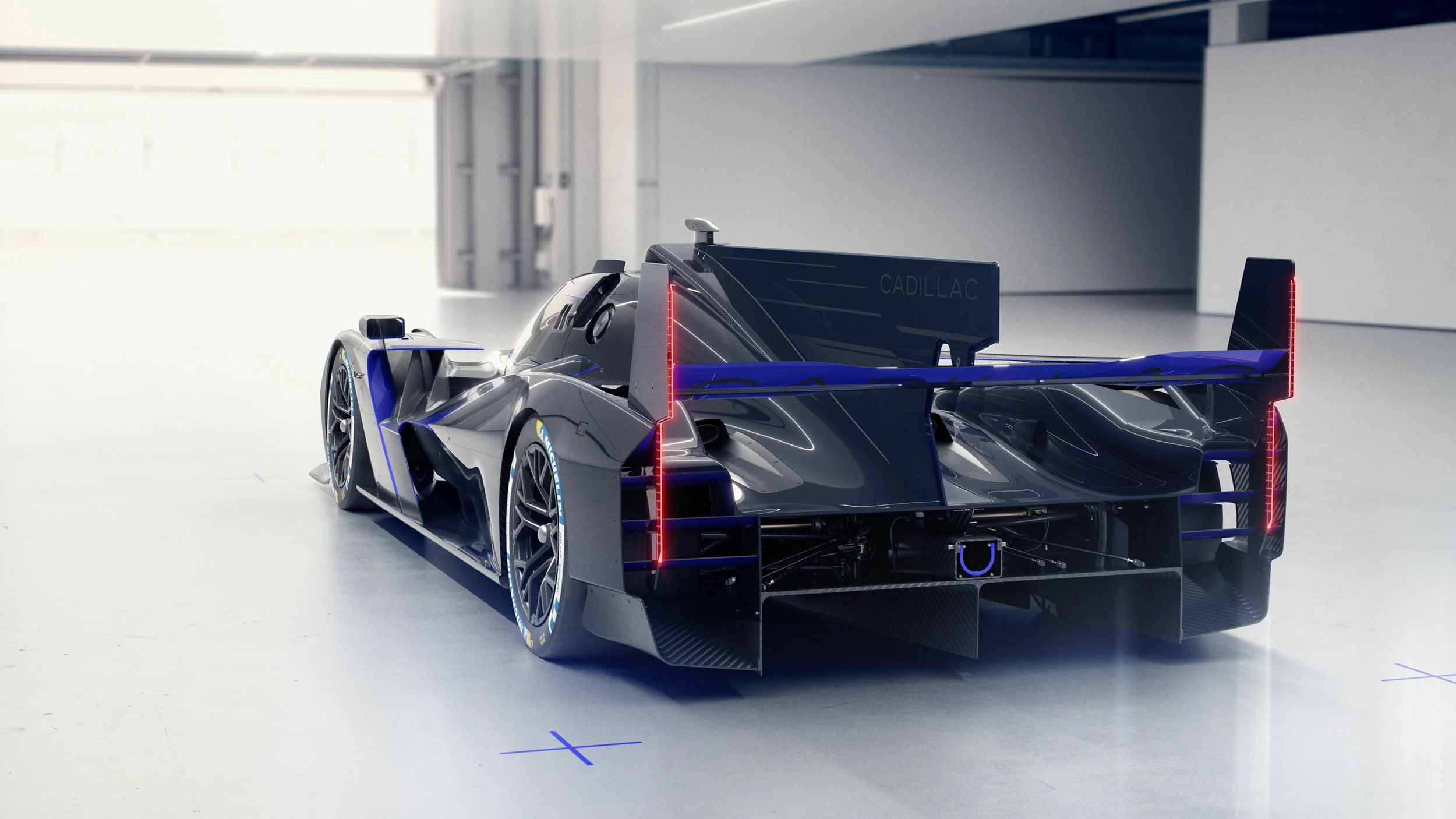 Photorealistic CGI render of a silver and blue Cadillac V-Series.R race car, showcasing high-end automotive visualisation, lighting, and post-production retouching.g.ing.n retouching.