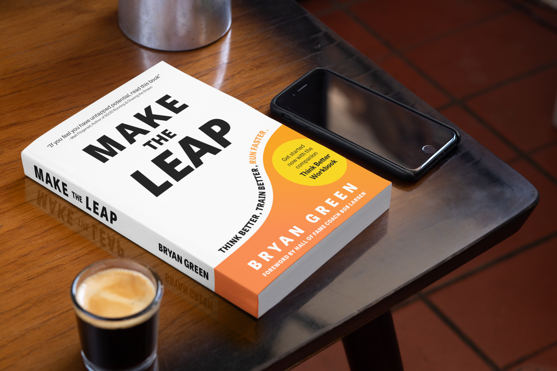 mockup-of-a-book-on-a-table-with-a-phone-and-a-coffee-33904.png