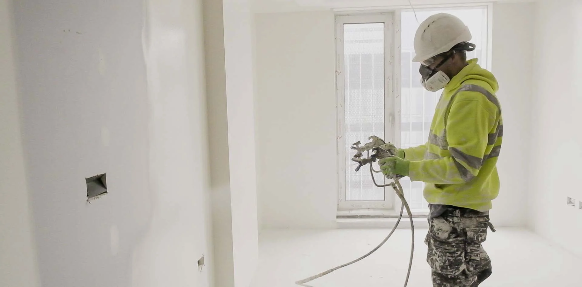Contractor applying Terrix spray plaster over Ramco Hilux fibre cement boards as part of an internal wall system